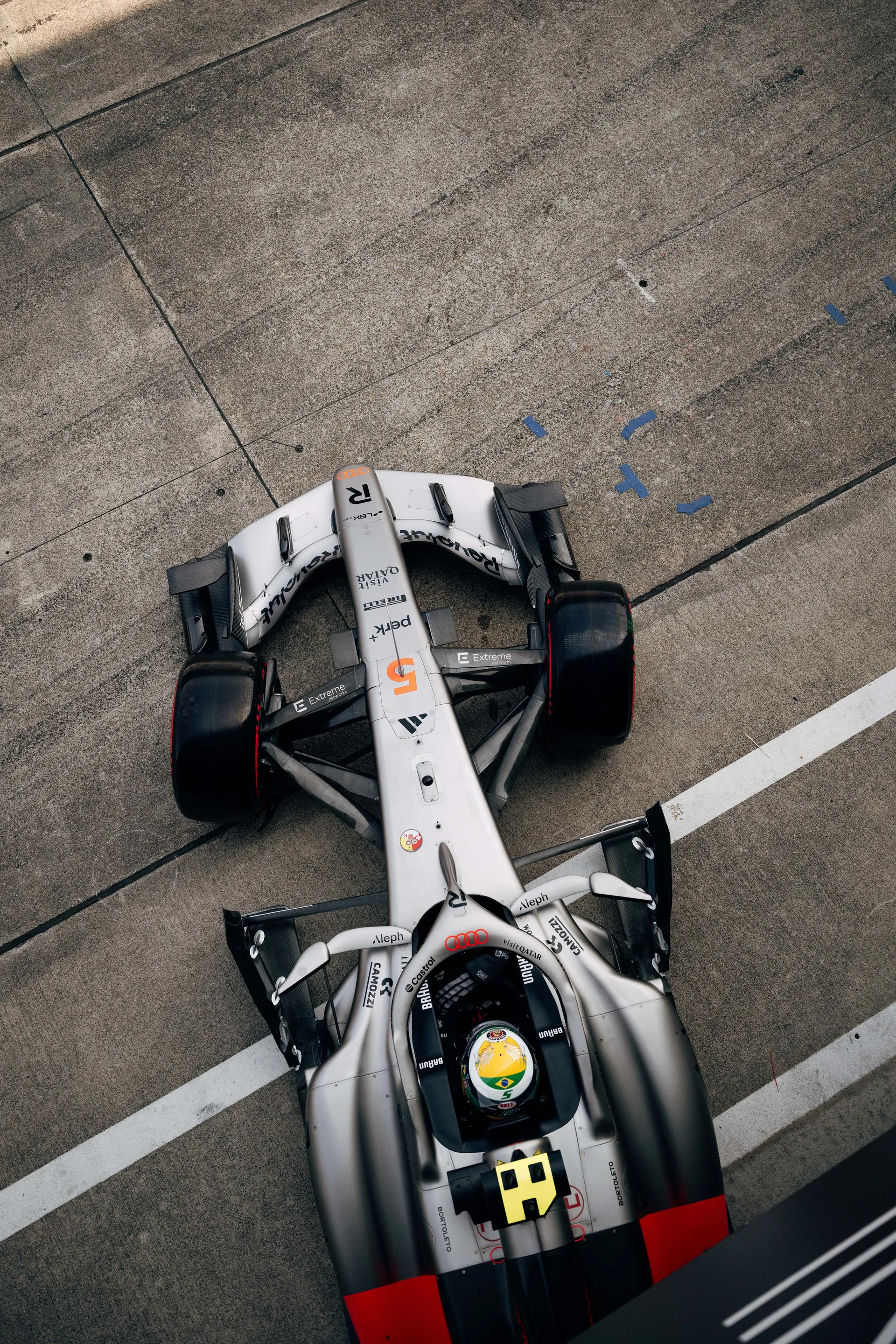 Overhead view of Gabriel Bortoleto in car number 5 waiting in the pit lane.