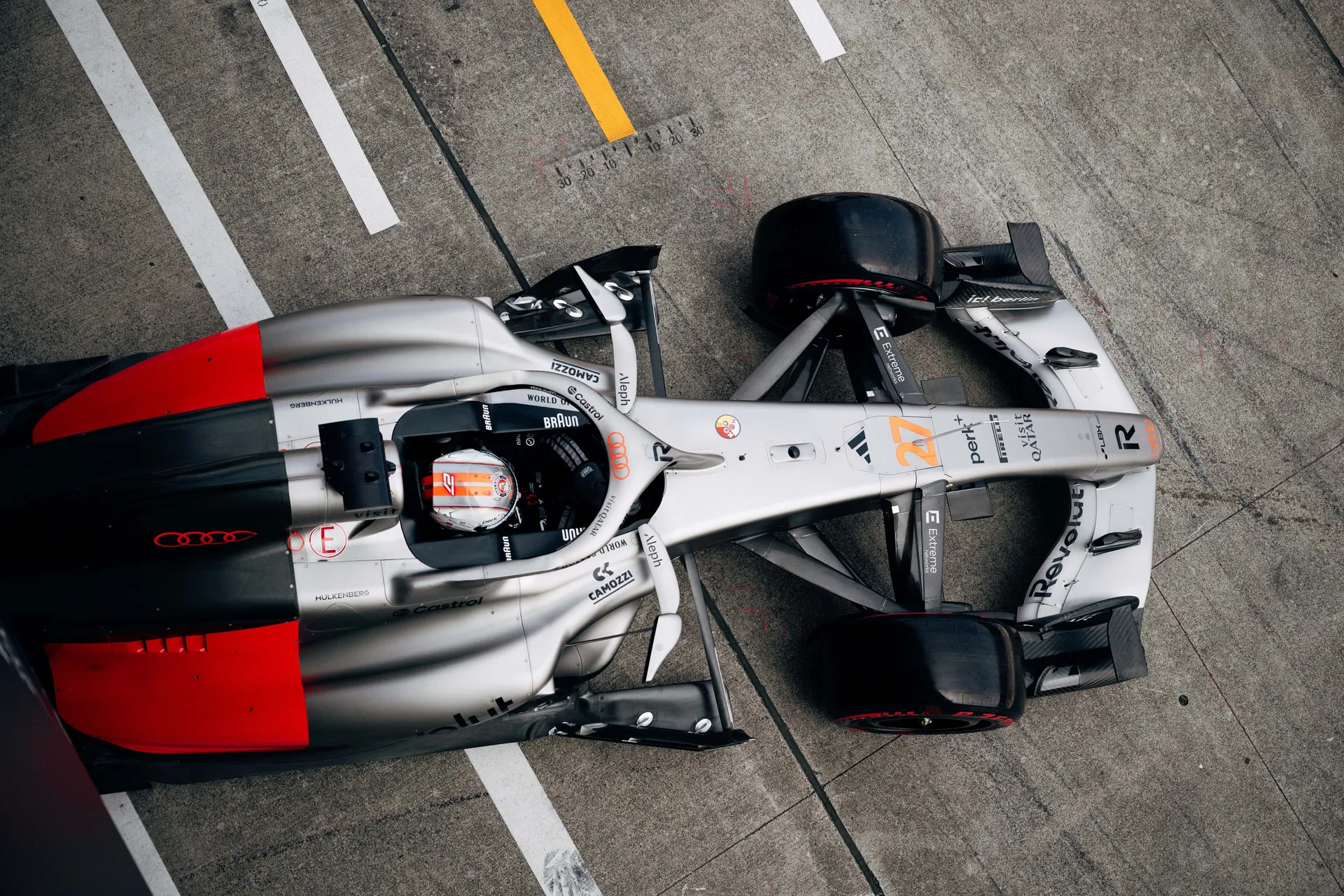 Overhead view of Nico Hulkenberg in car number 27 in the pit lane.