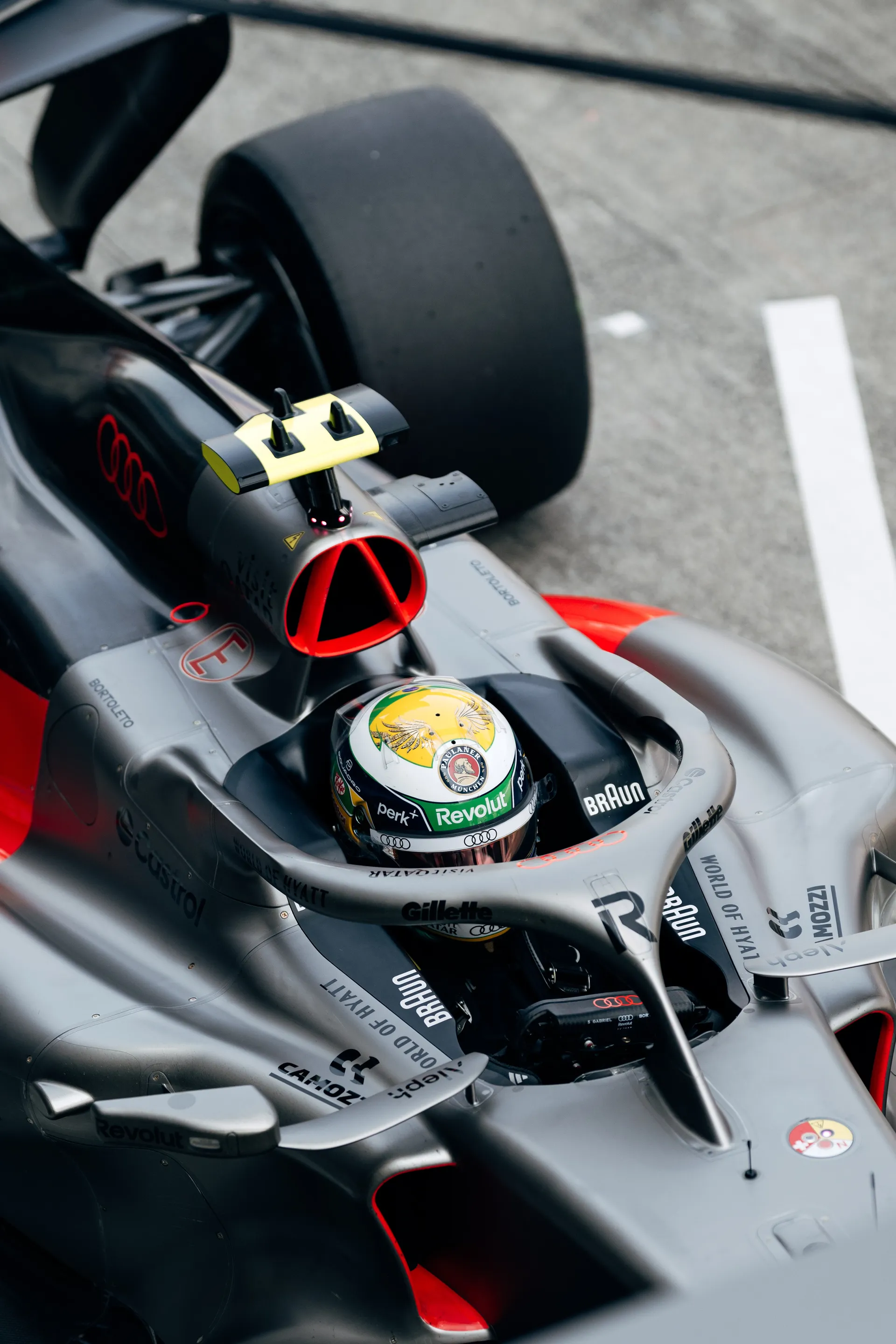 Close high angle detail of Gabriel Bortoleto seated in the Audi Revolut F1® Team car.