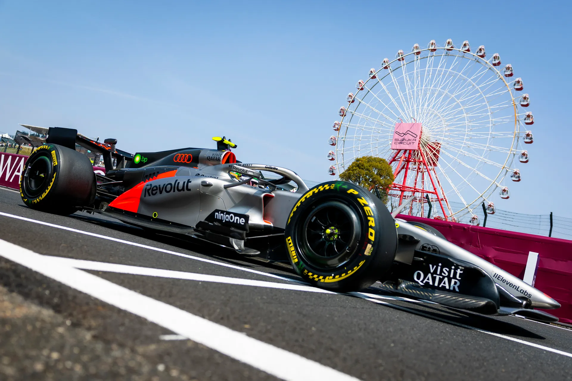 Gabriel Bortoleto in the Audi Revolut F1® Team car passes the Suzuka Circuit ferris wheel during track action.