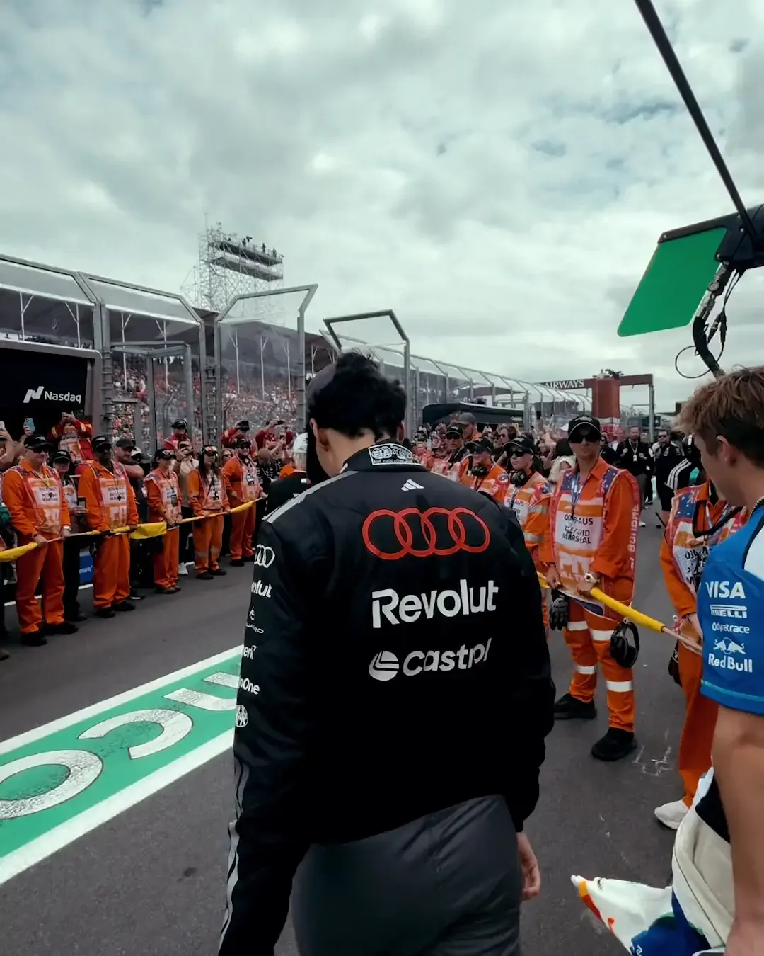 Audi Revolut F1® Team driver walking to the parade vehicle in front of the Melbourne grandstands.