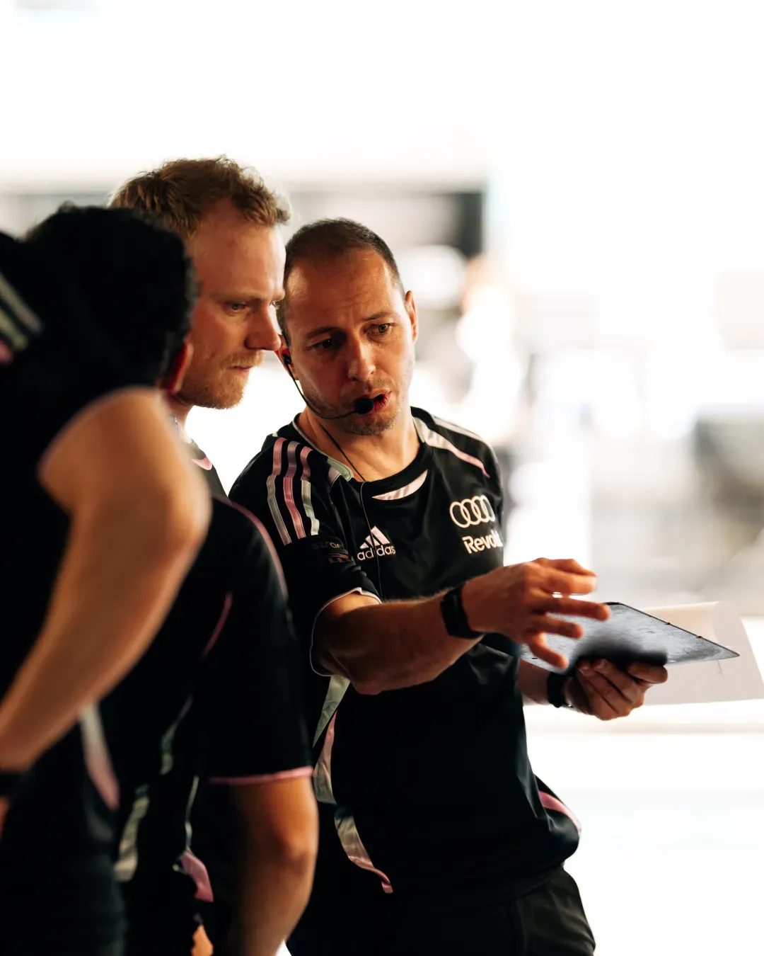 Team discussion in the garage