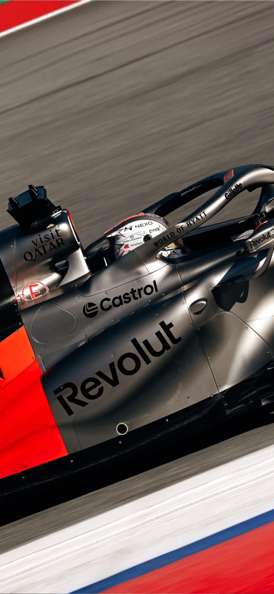 High-speed action shot of the Audi Revolut F1® Team car Audi R26 racing on track, with motion blur emphasizing performance and speed