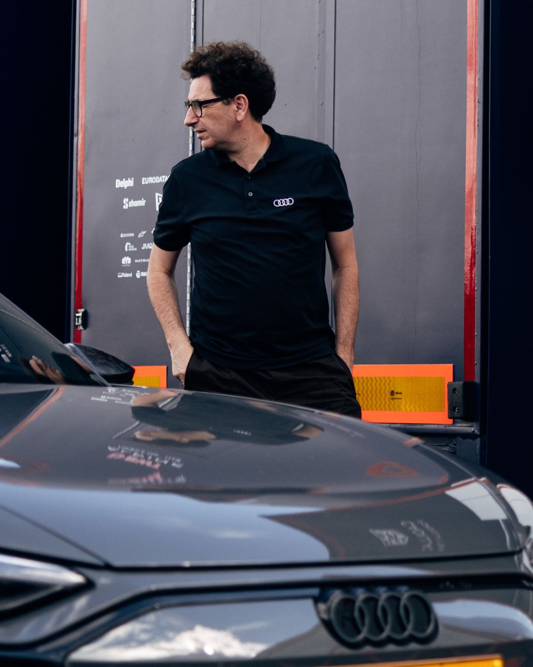 Audi Revolut team member at vehicle in Zandvoort paddock during race weekend arrival