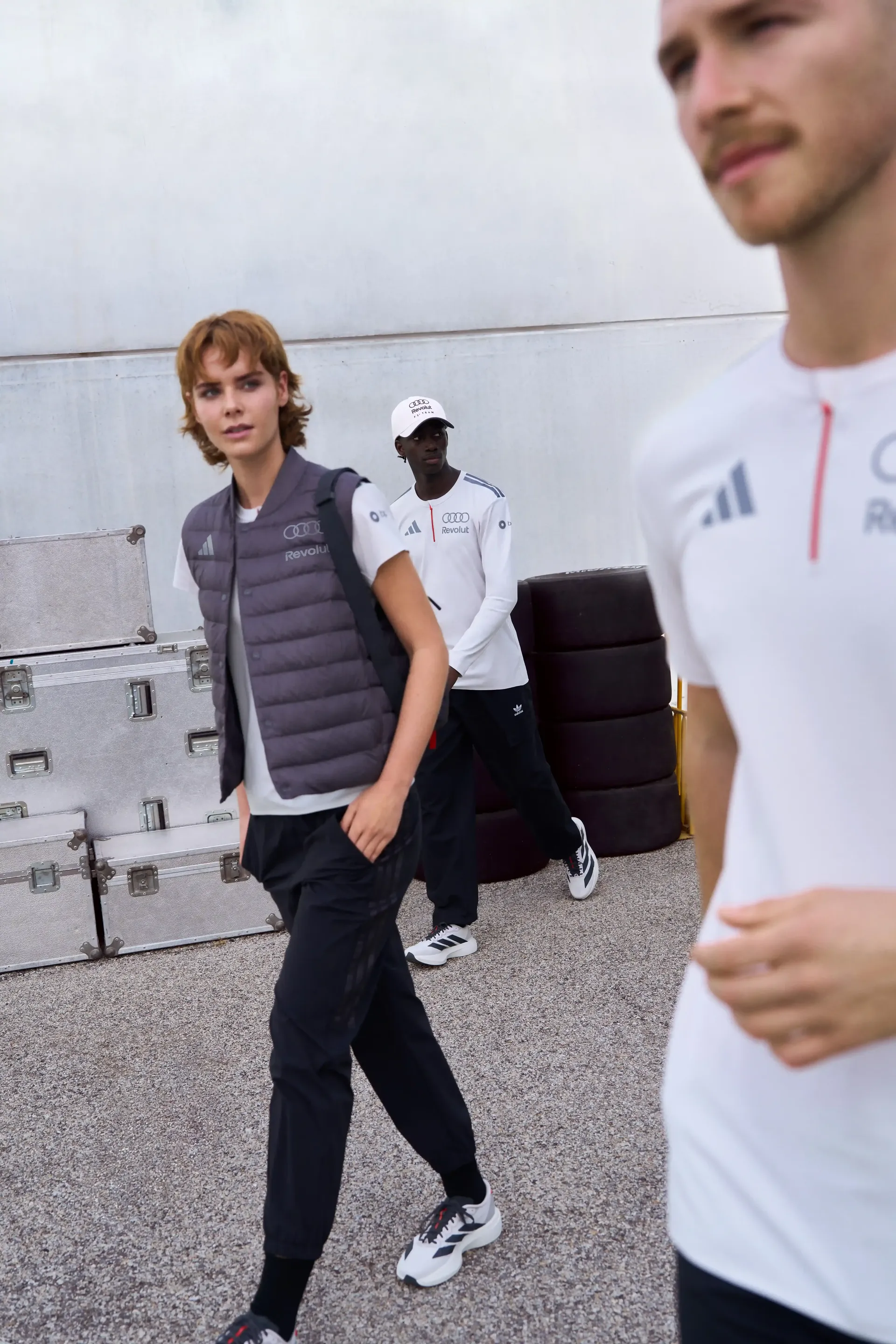 Three models in foreground and background urban setting grey teamwear natural movement modern street style