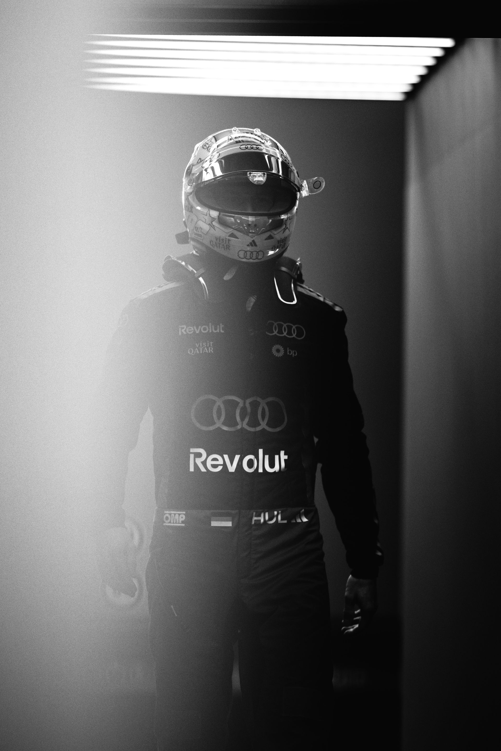 Black and white photo of Nico Hulkenberg walking in the pit