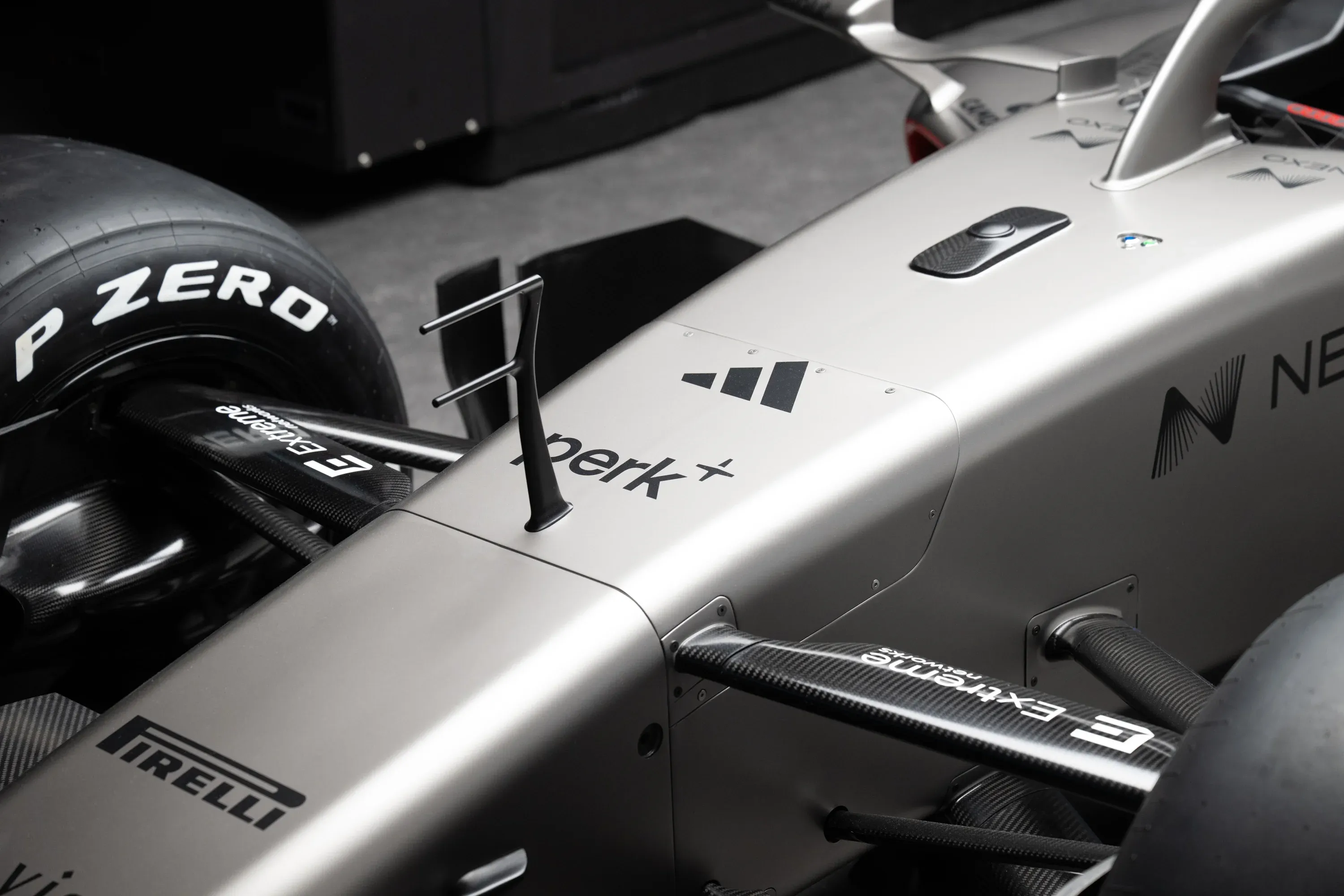 Partner logos Adidas, Perk, Pirelli on the R26 nose area of the car