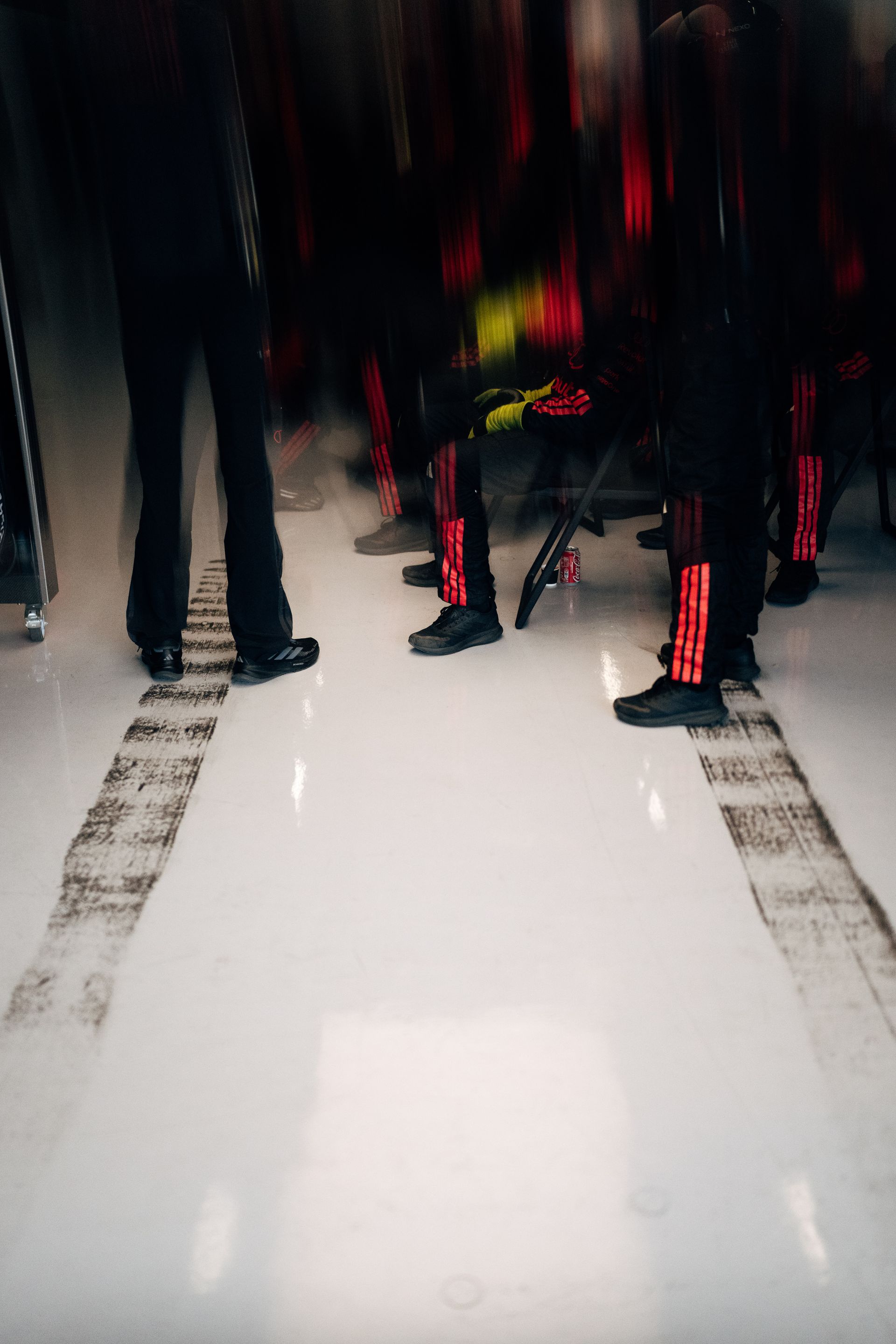 Blurred motion captures the Audi R26 entering the pit box as Audi Revolut F1® Team crew prepare for a pit stop.