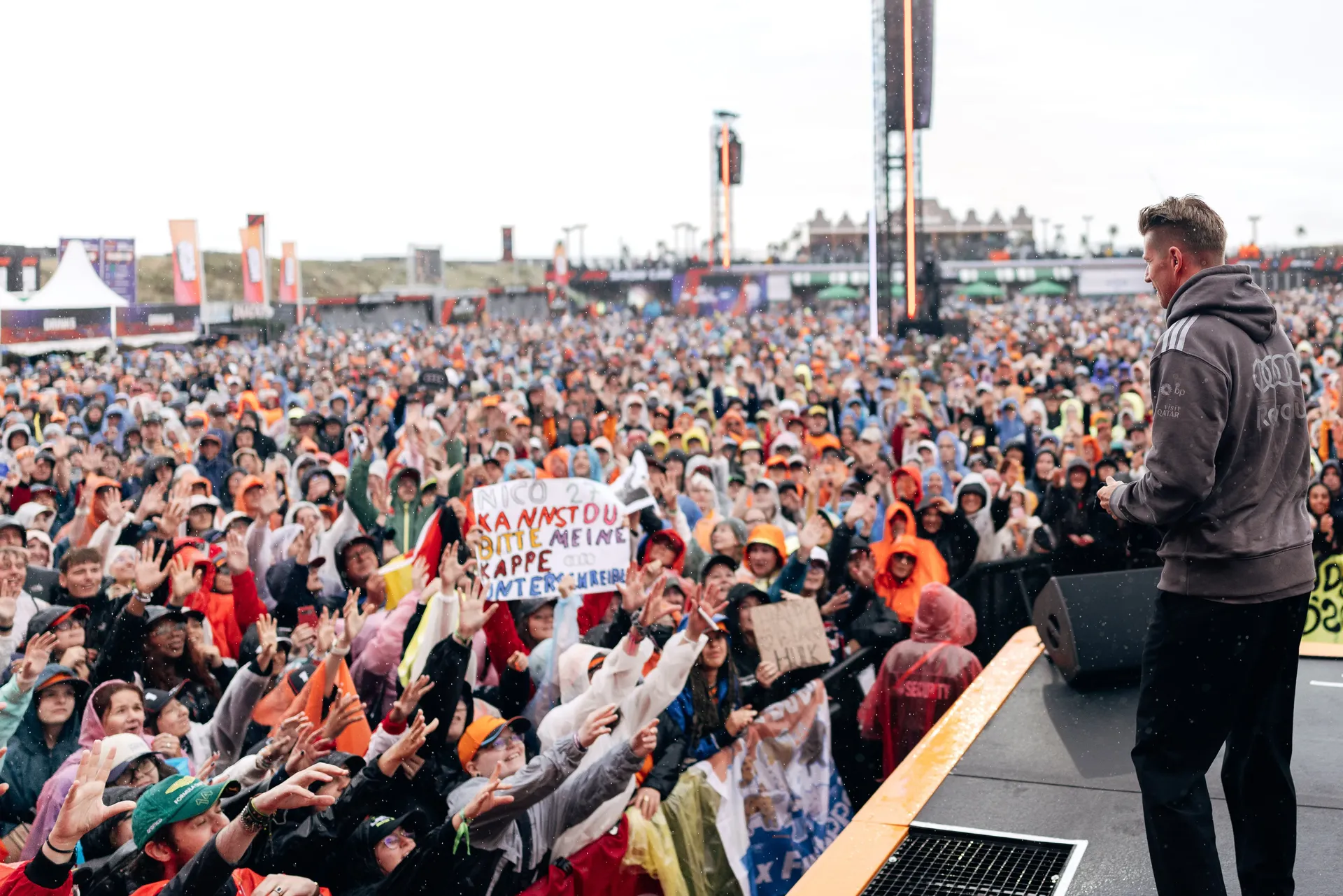 Team member addressing large crowd of Audi Revolut F1 supporters at Zandvoort circuit