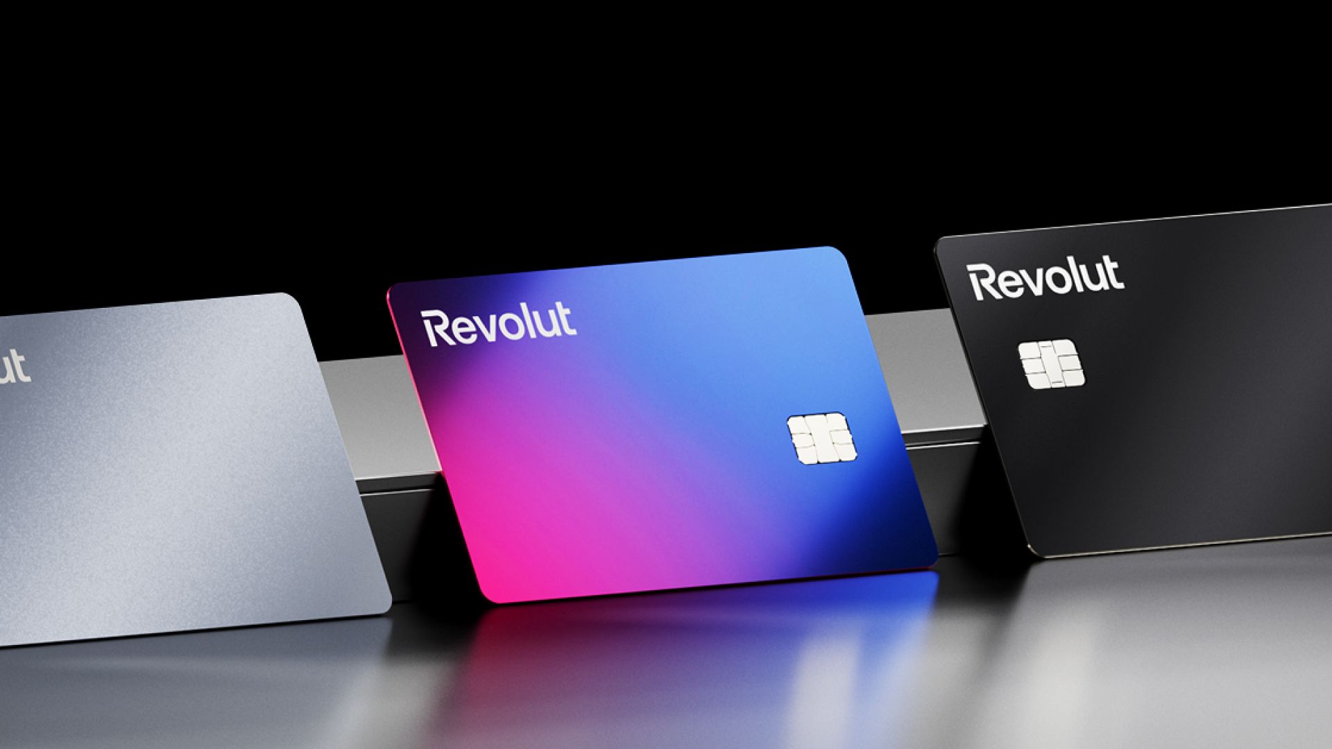 Three Revolut cards in Silver, Purple and black