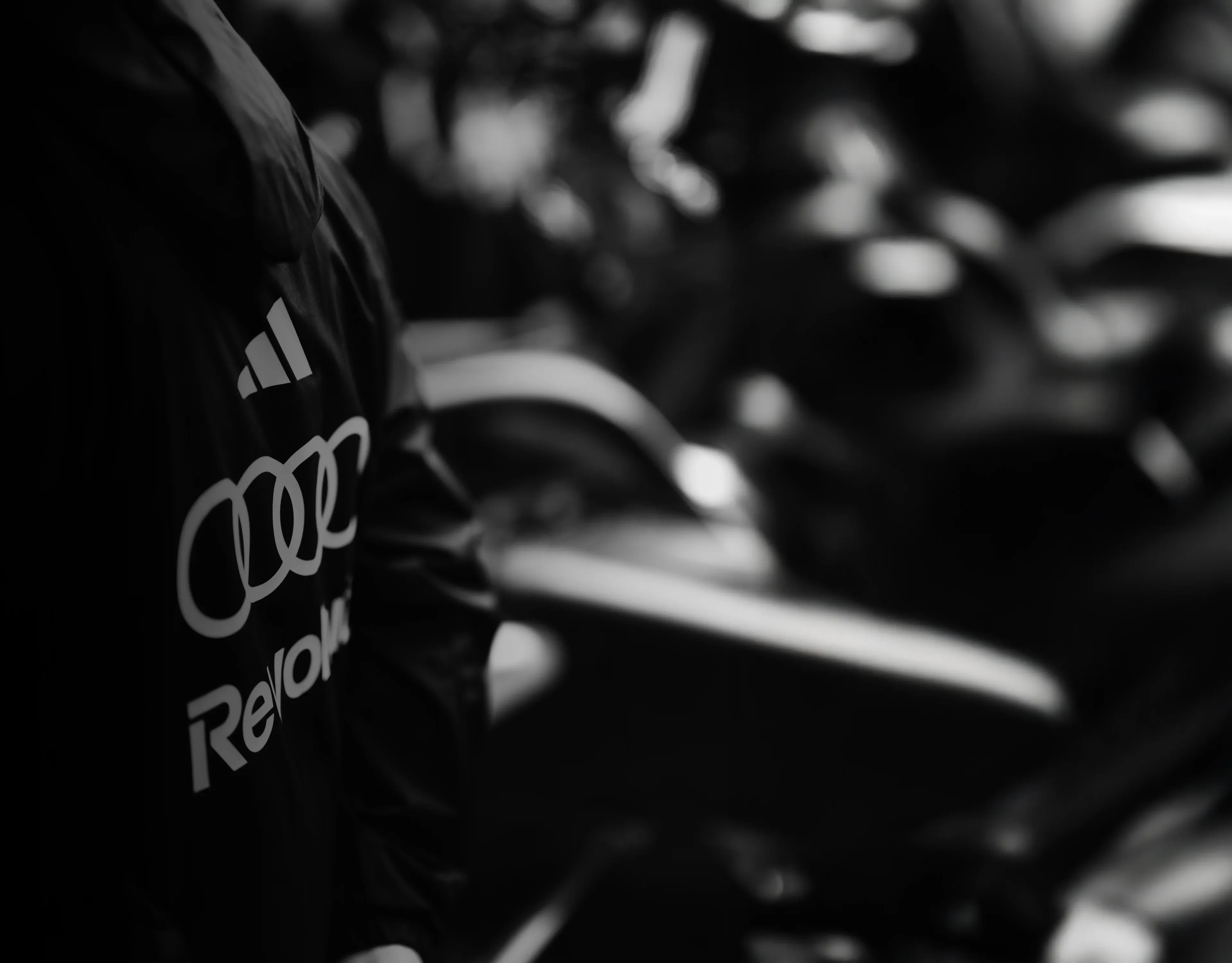 Teamwear jacket with Adidas, Audi and Revolut sponsor logos on it 