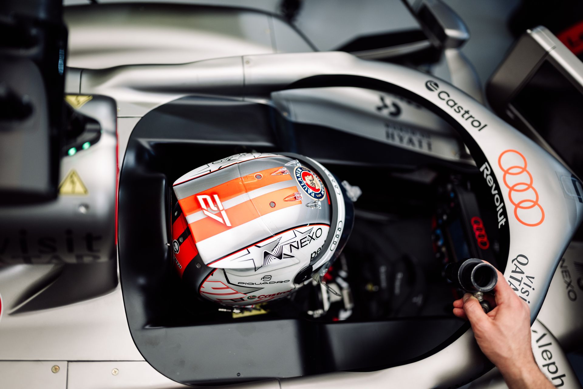 Nico Hulkenberg wearing his helmet and sitting in the car from top view in the cockpit