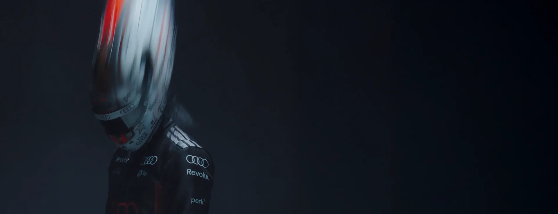 Nico Hulkenberg on a dark background with helmet and race suit