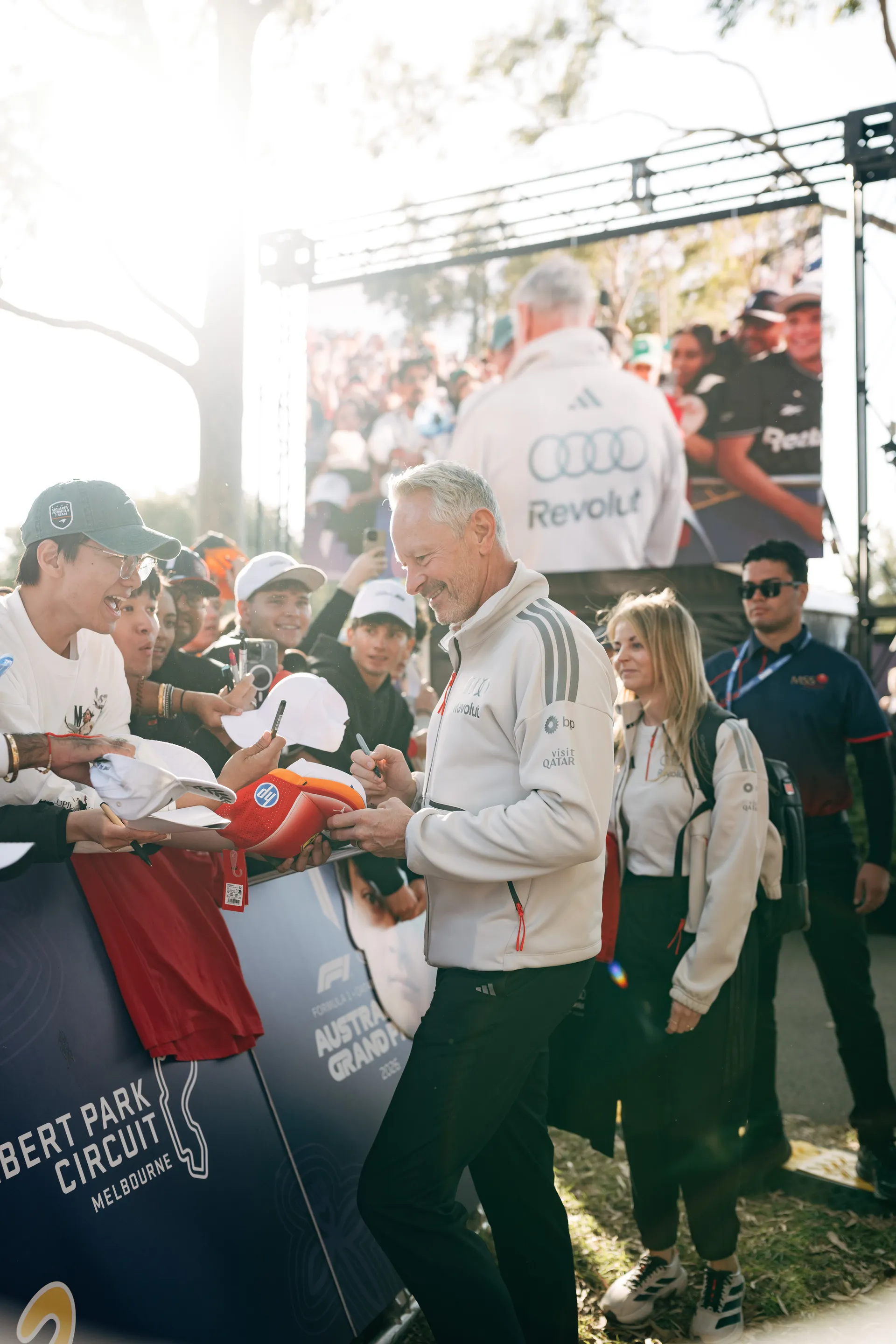 Audi Revolut F1® Team representative Jonathan Weathley signs caps and memorabilia for fans at Albert Park Circuit in Melbourne.