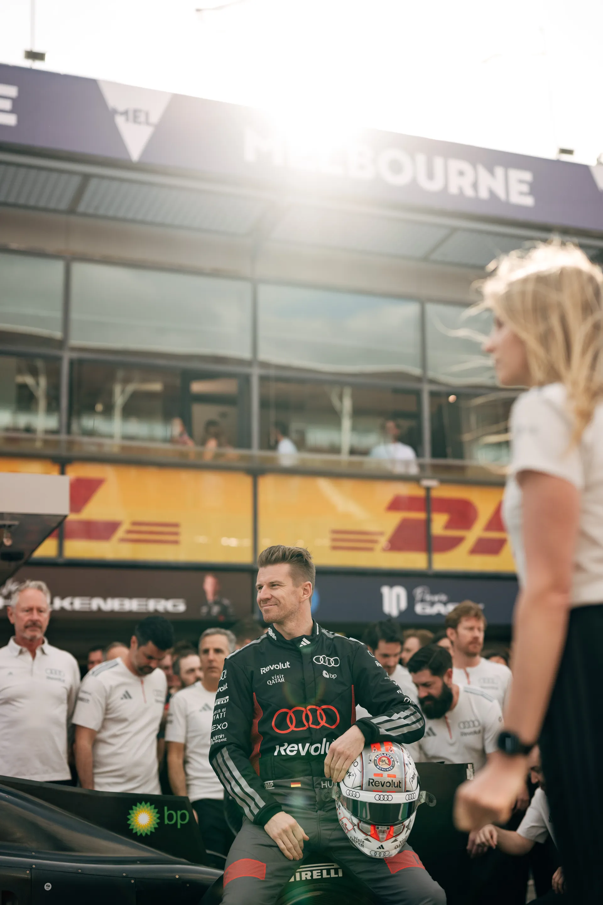 Audi Revolut F1® Team driver Nico Hulkenberg poses with helmet in front of the garage during pre race grid activity in Melbourne.