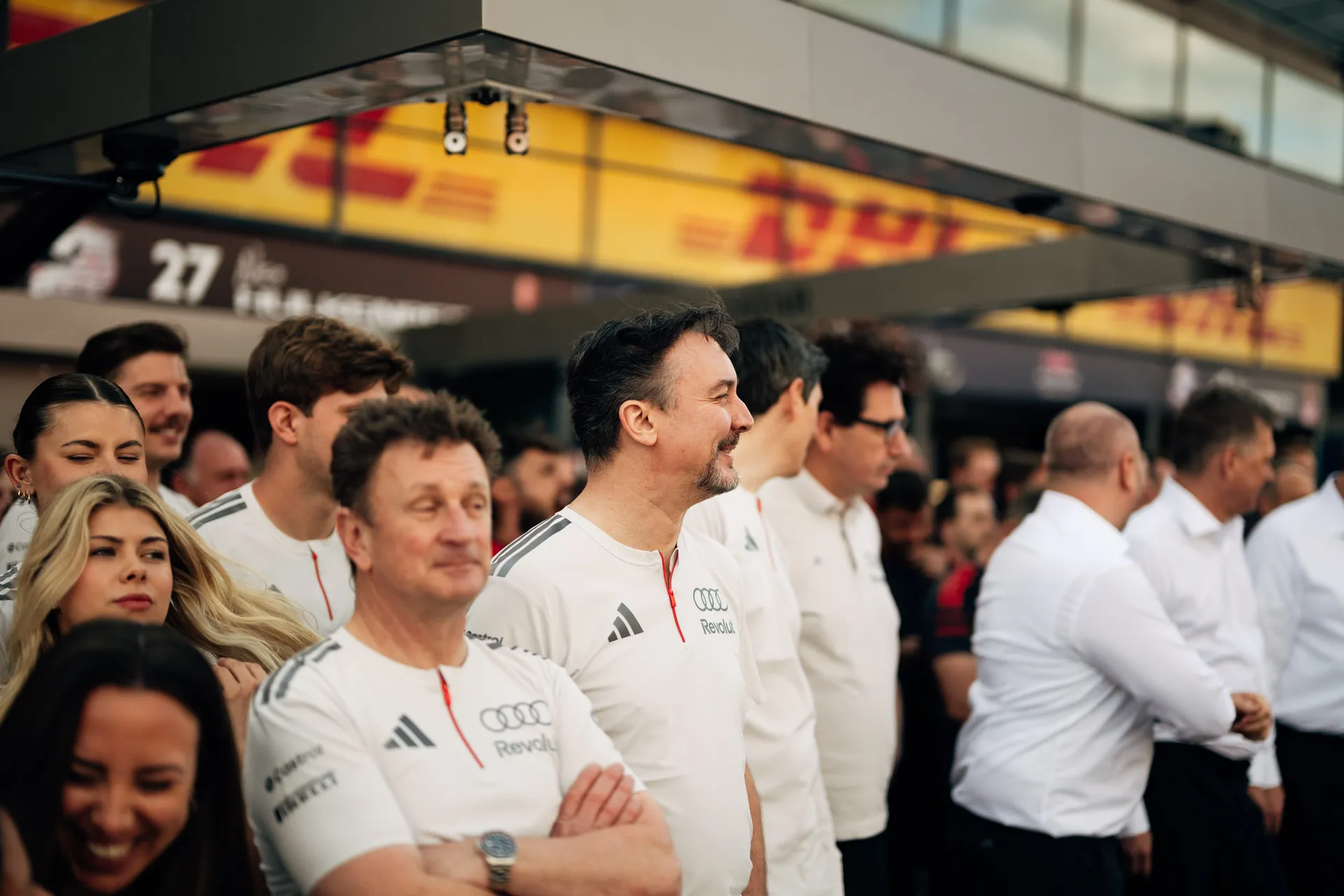 Audi Revolut F1® Team members and guests stand together in the pit lane during pre race ceremonies in Melbourne.