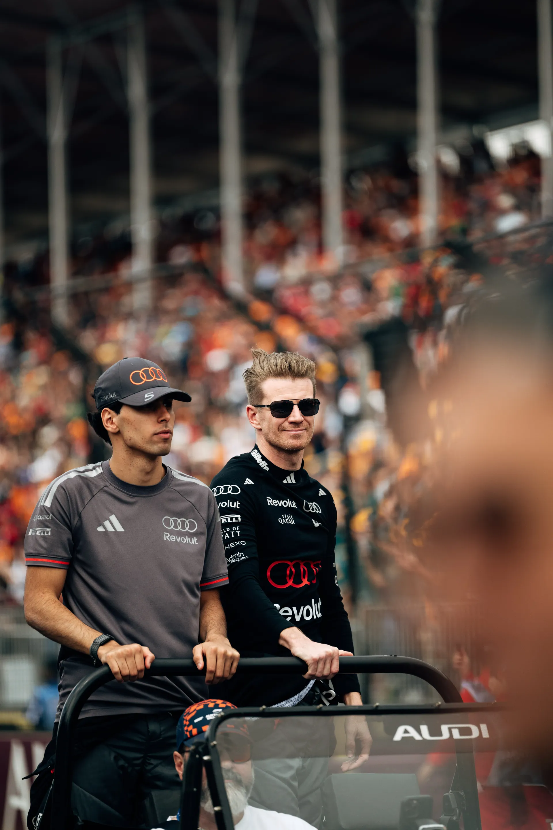 Audi Revolut F1® Team drivers Nico Hulkenberg and Gabriel Bortoleto wave to the crowd from a parade vehicle during the Melbourne drivers parade.