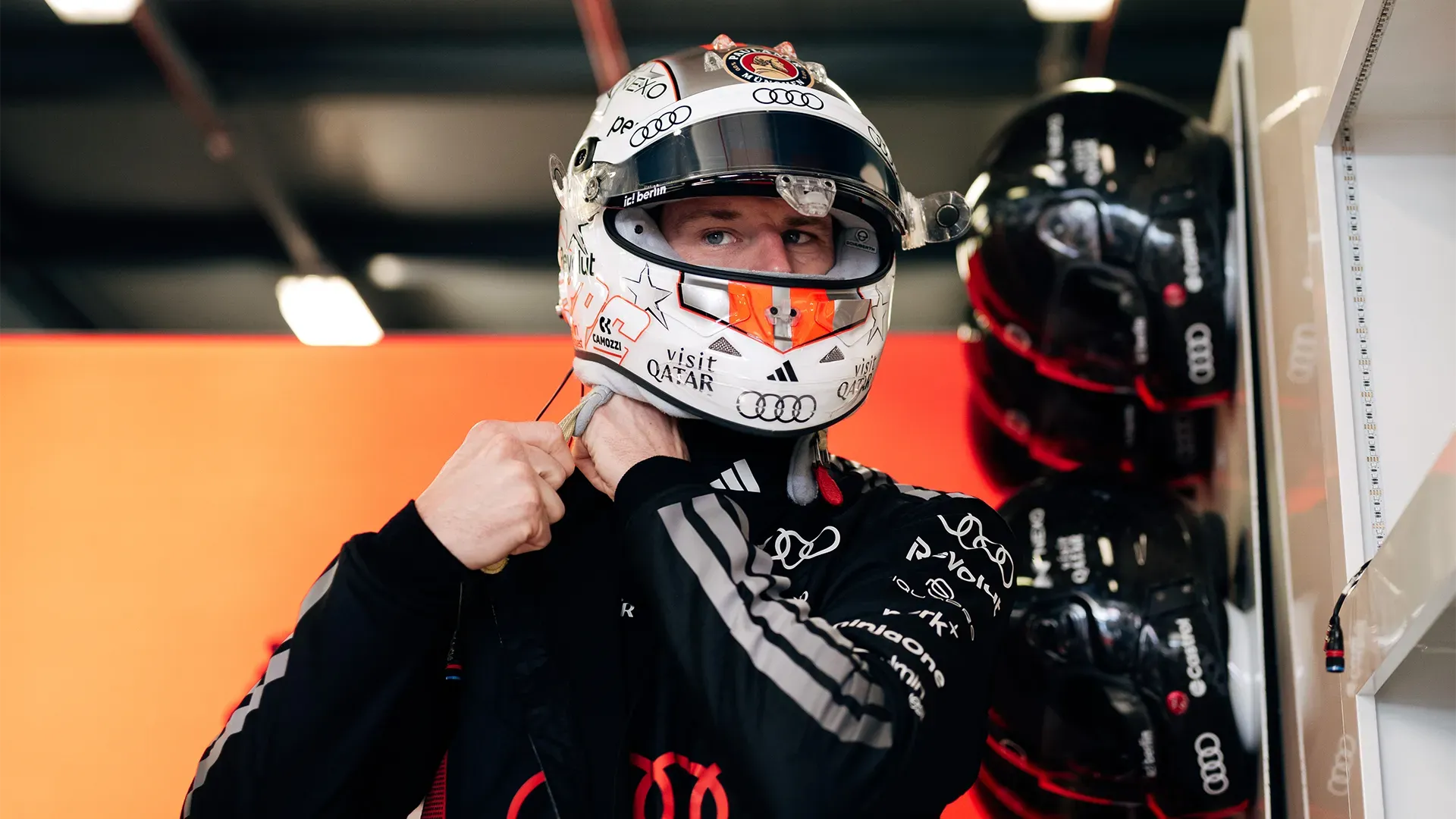 Nico is taking his helmet on and gets ready for FP1