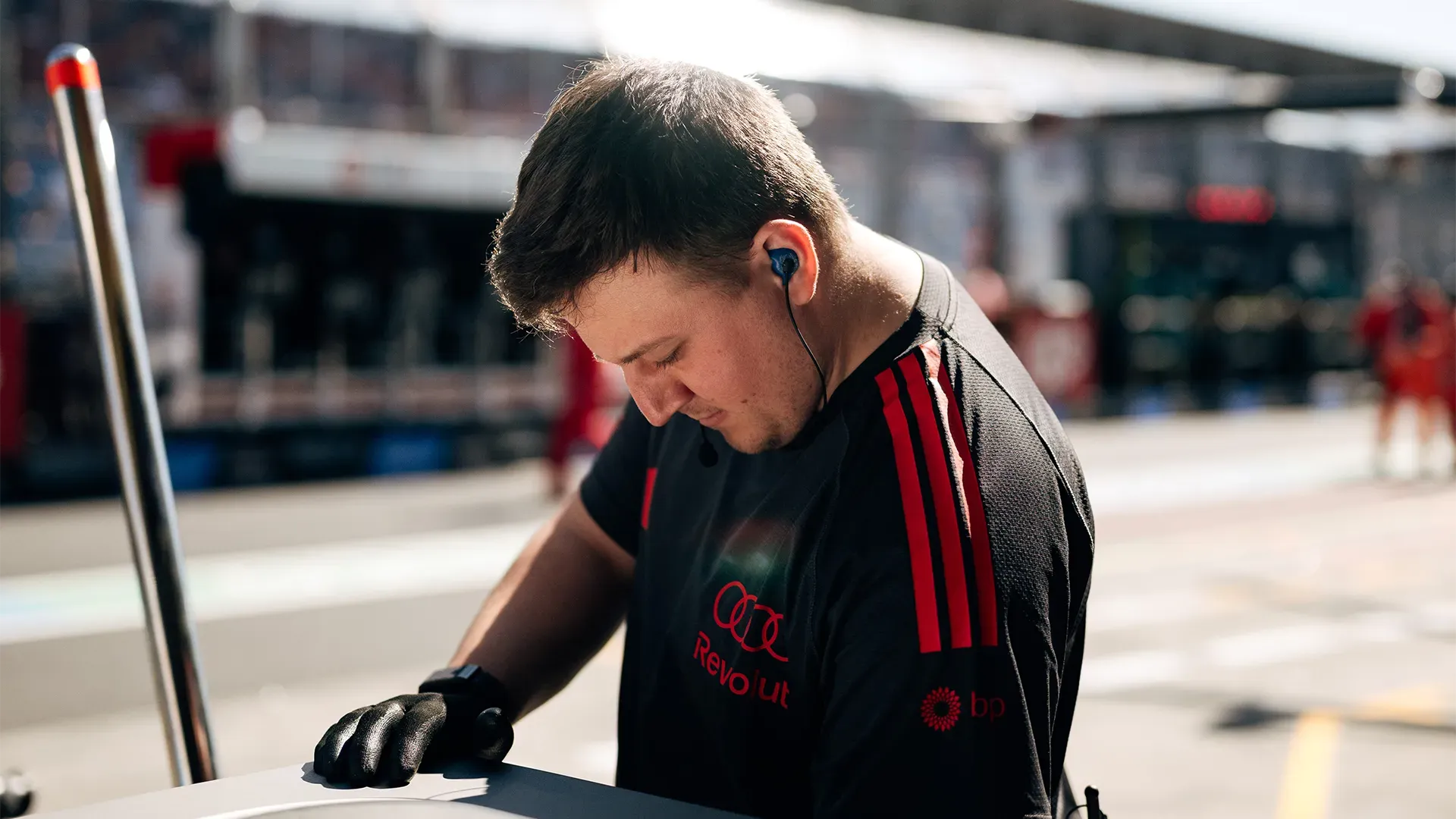 A mechanic is working in front of the pit