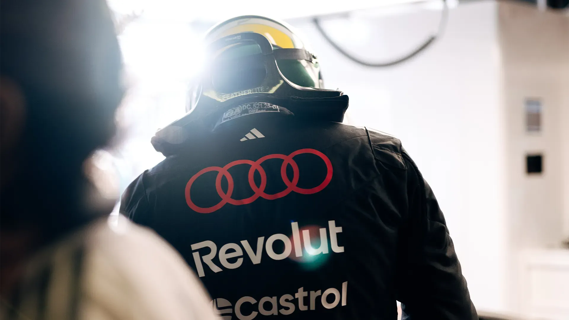 Gabi from behind with helmet entering the car