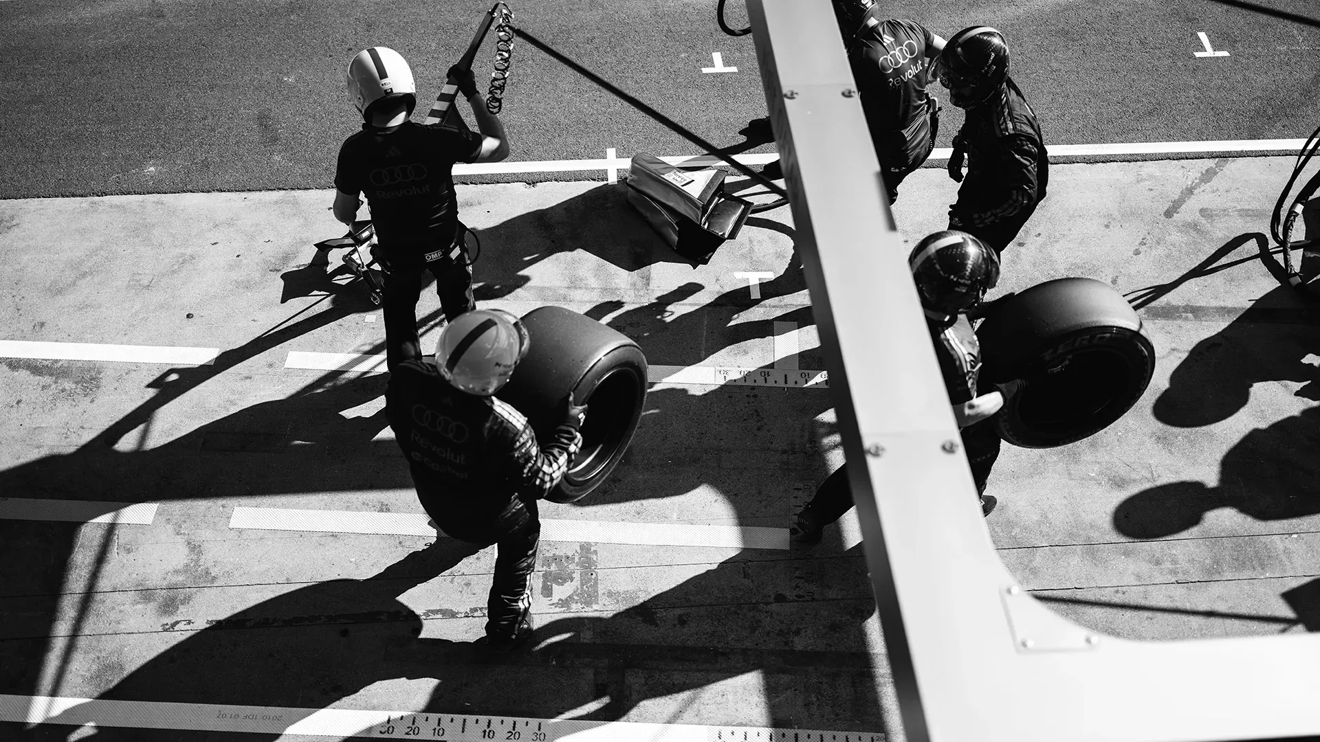 Top view in front of the pit where the crew practicing a pit stop