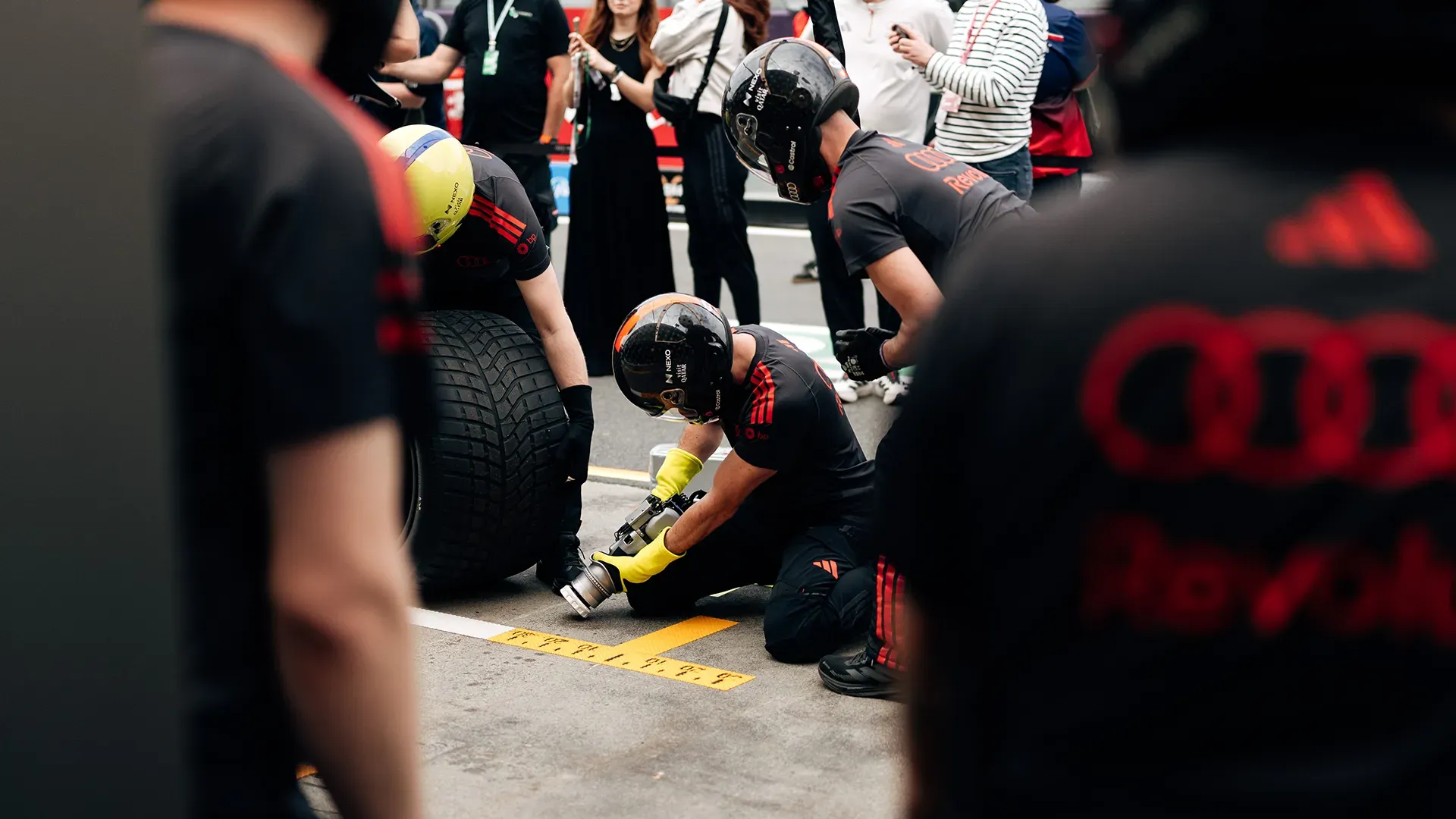 The pit crew is setting up to receive the car