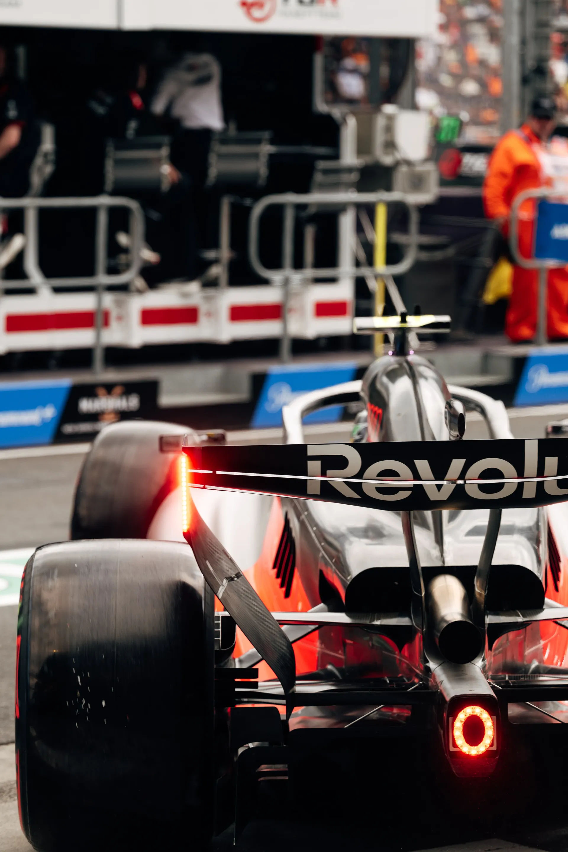 Rear view of the Audi Revolut F1® Team Formula 1 car in the pit lane with glowing rain light during qualifying.