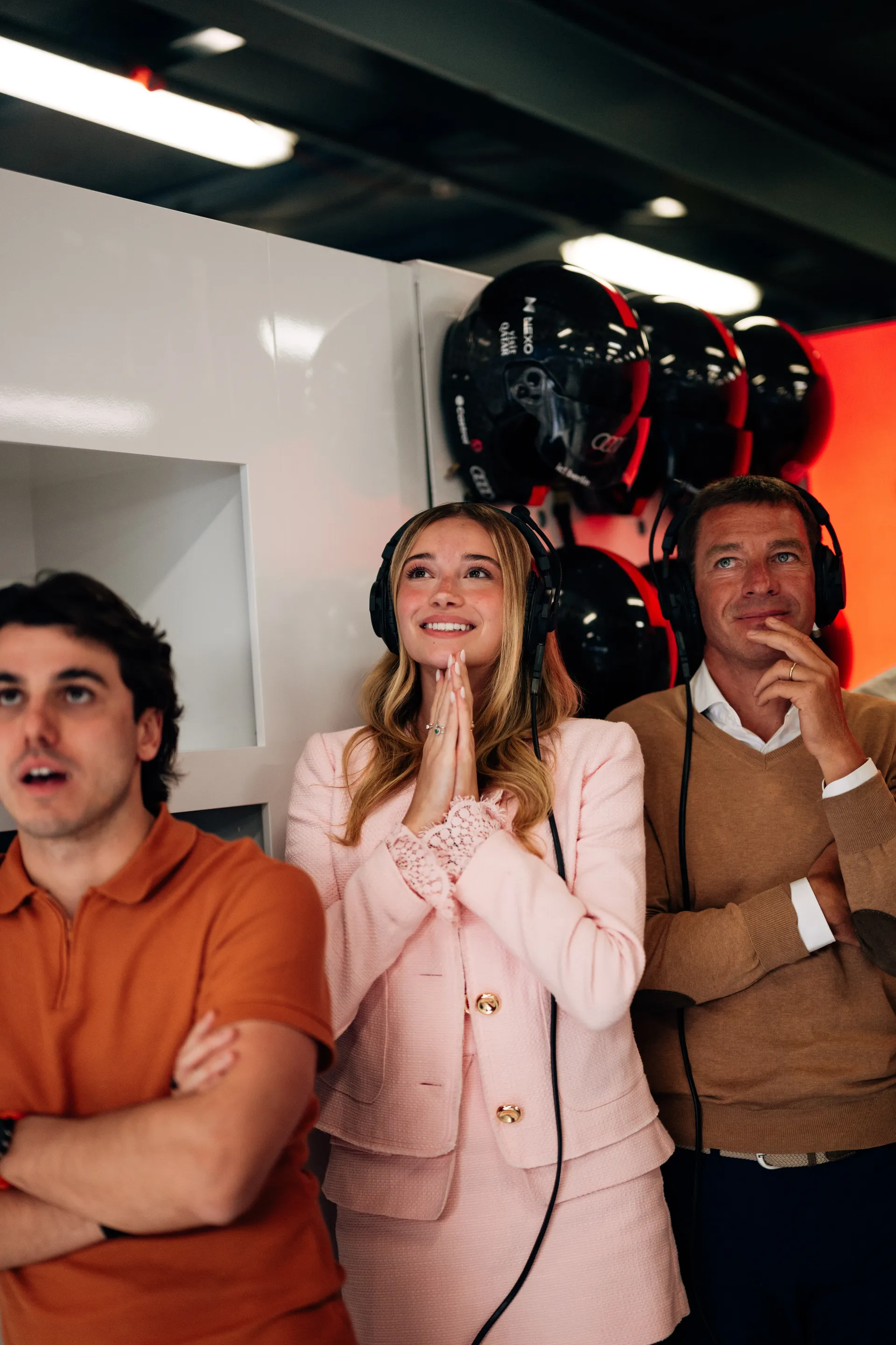 Guests wearing headsets watch the action from inside the Audi Revolut F1® Team garage during qualifying.