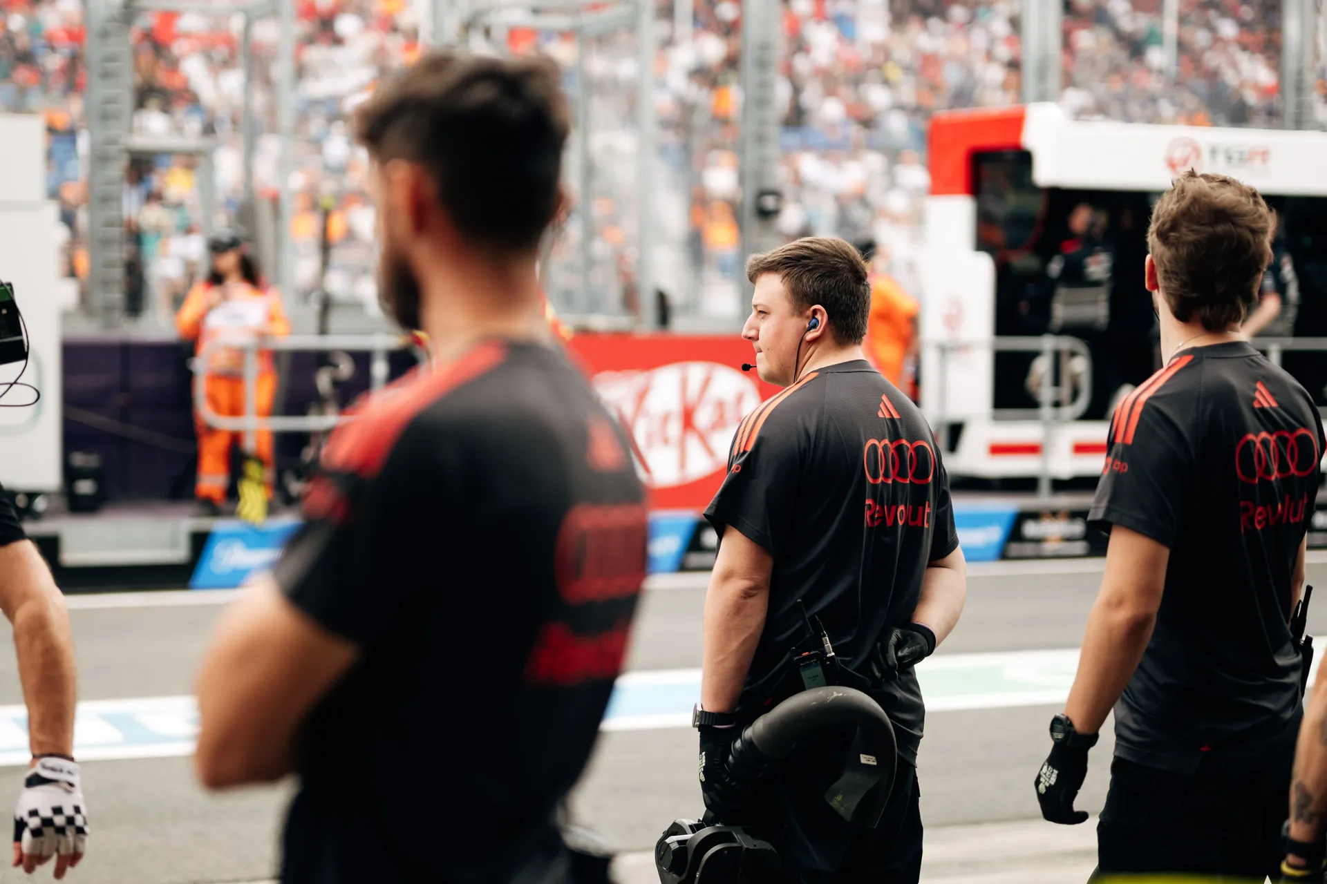 Audi Revolut F1® Team pit crew stand at the edge of the garage watching the pit lane during qualifying.