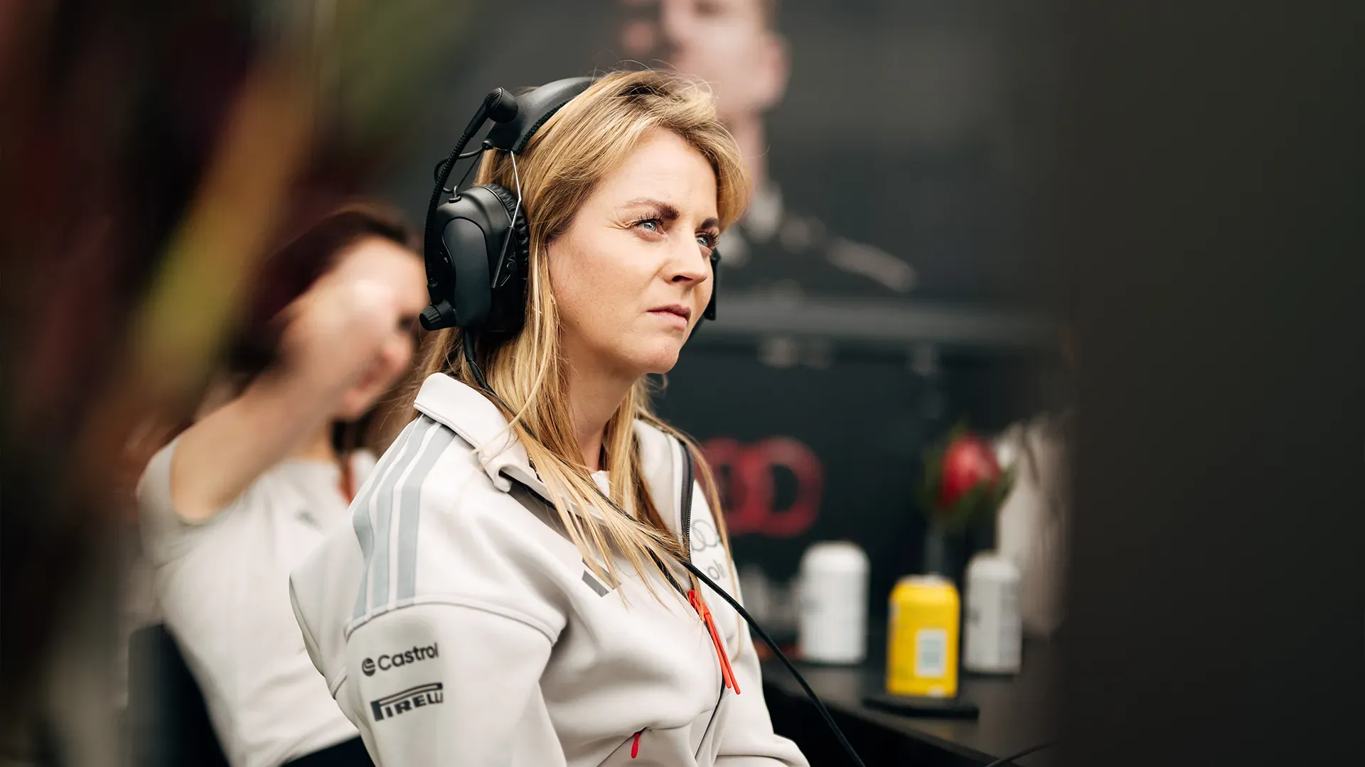 A woman from the team listening during preparation talk with the whole team