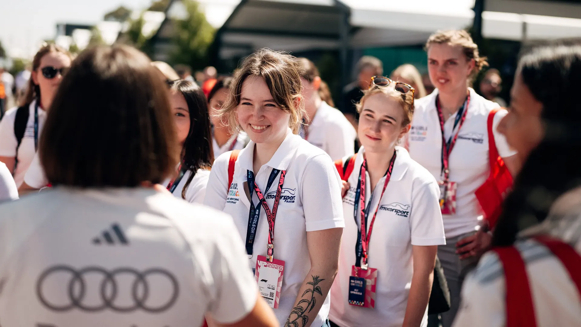 A Girl is standing in the group and smiles