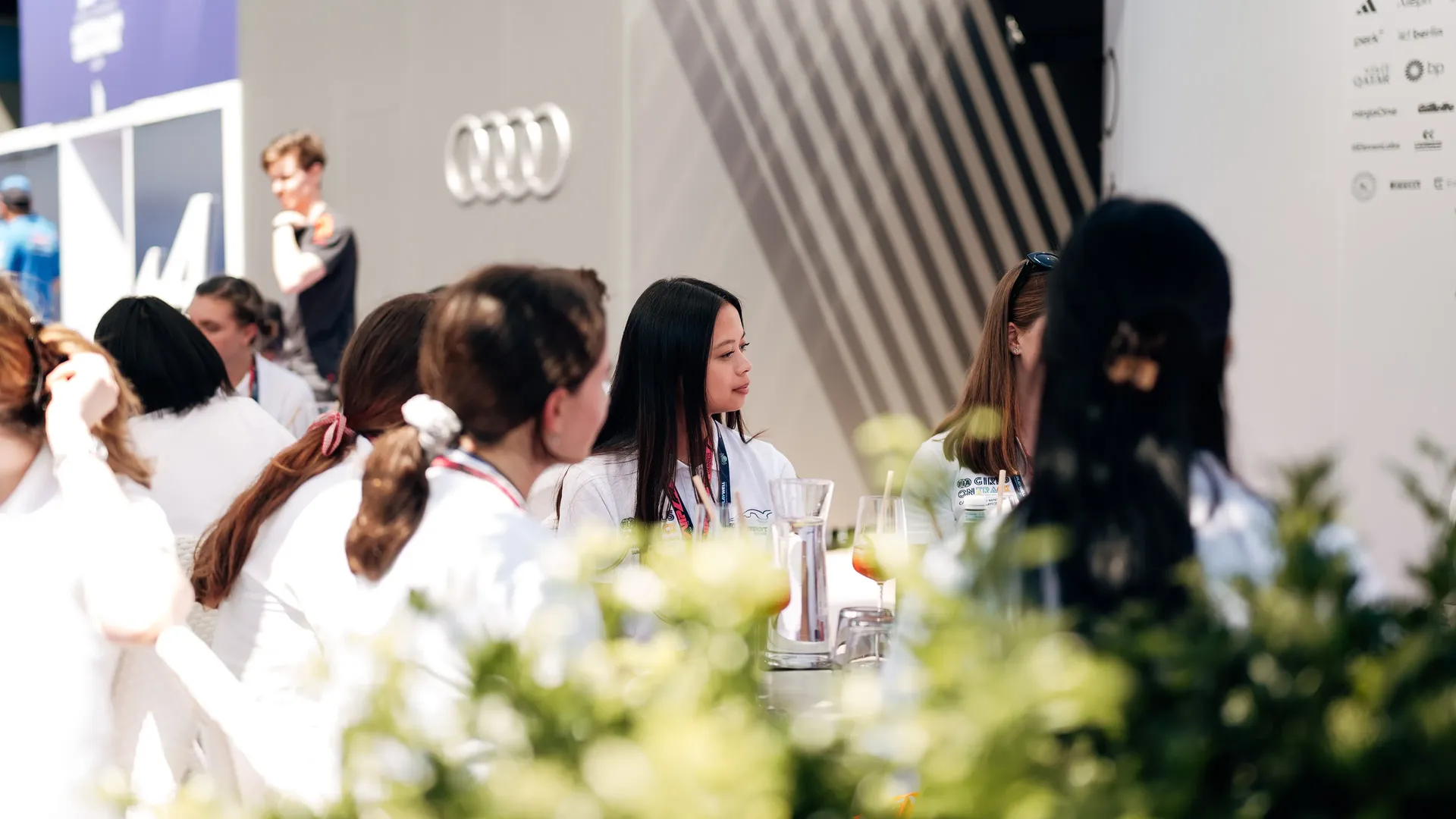 Girls sitting on a table and talking to each other