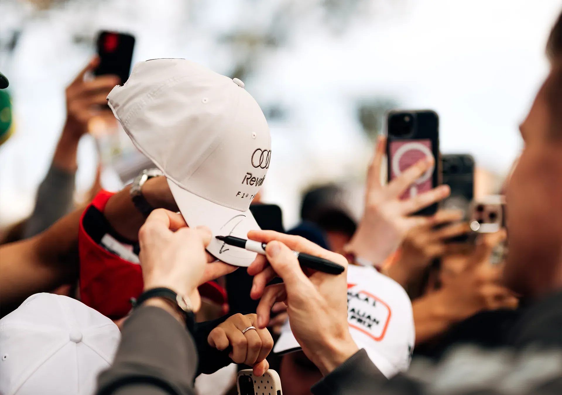 Nico signing a cap from a fan