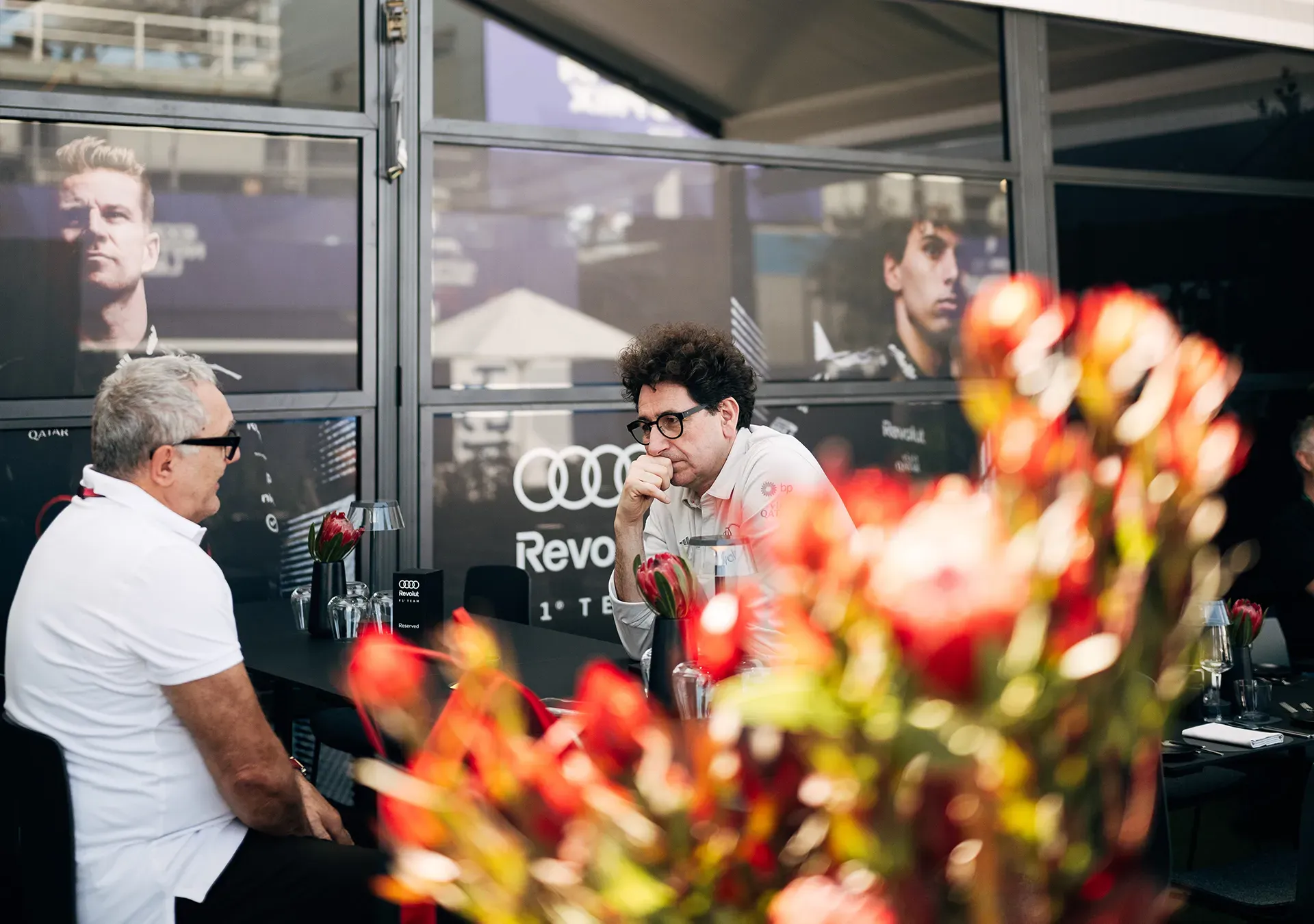 Mattia Binotto talking to a team member in the Paddock