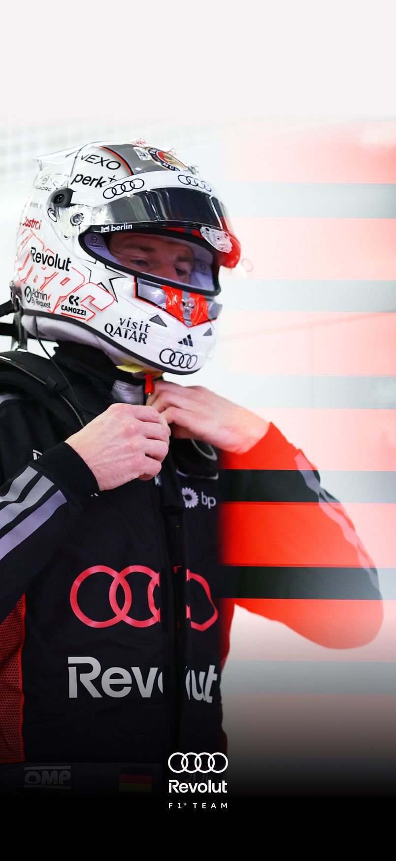 Close-up of Nico Hulkneberg athlete of the Audi Revolut F1® Team adjusting the chin strap of a white helmet with Audi and sponsor branding, dressed in a black Audi racing suit, with motion blur and red light streaks in the background.