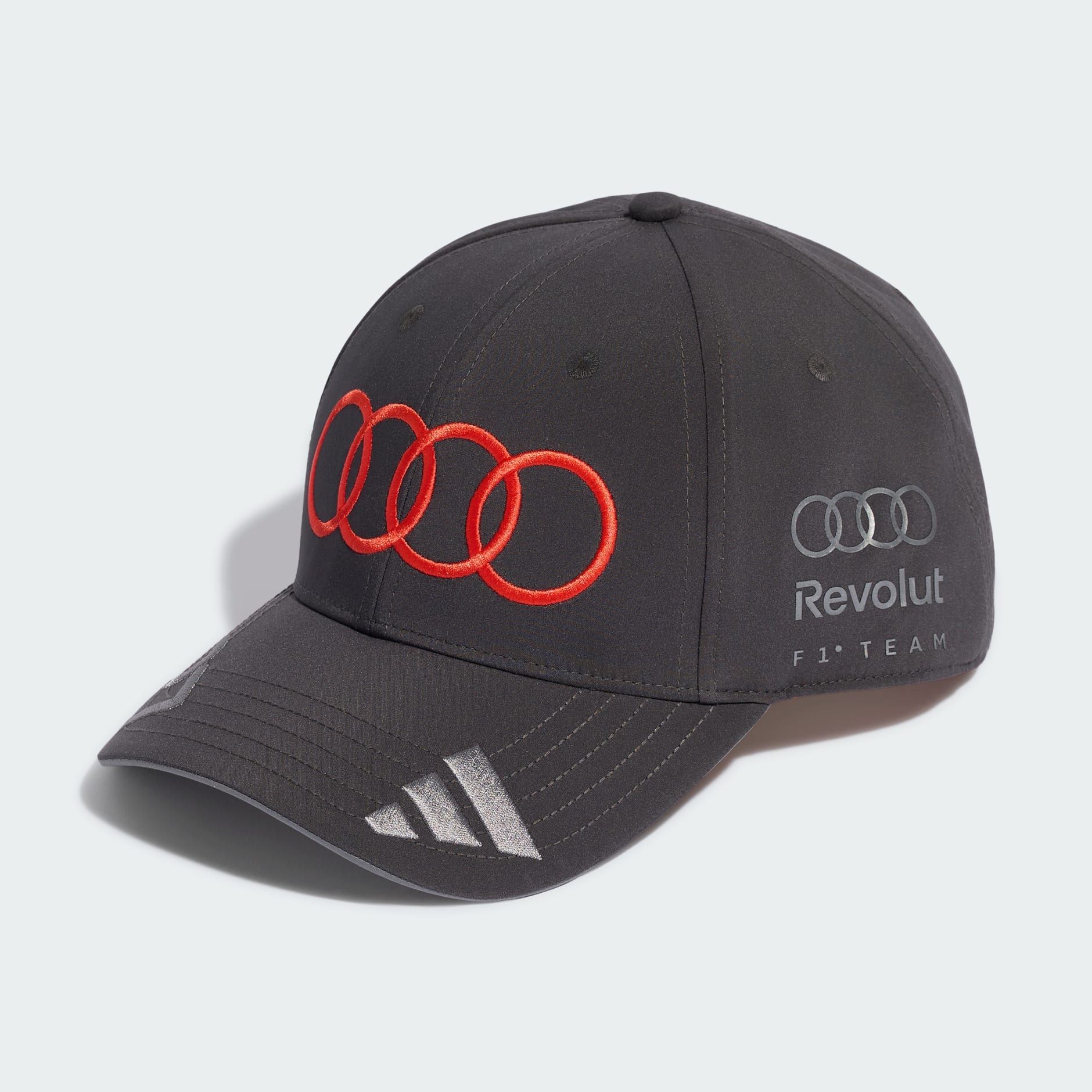 Audi Revolut F1® Team cap, dark greay with red Audi Rings and grey adidas Logo, side view front, in the studio