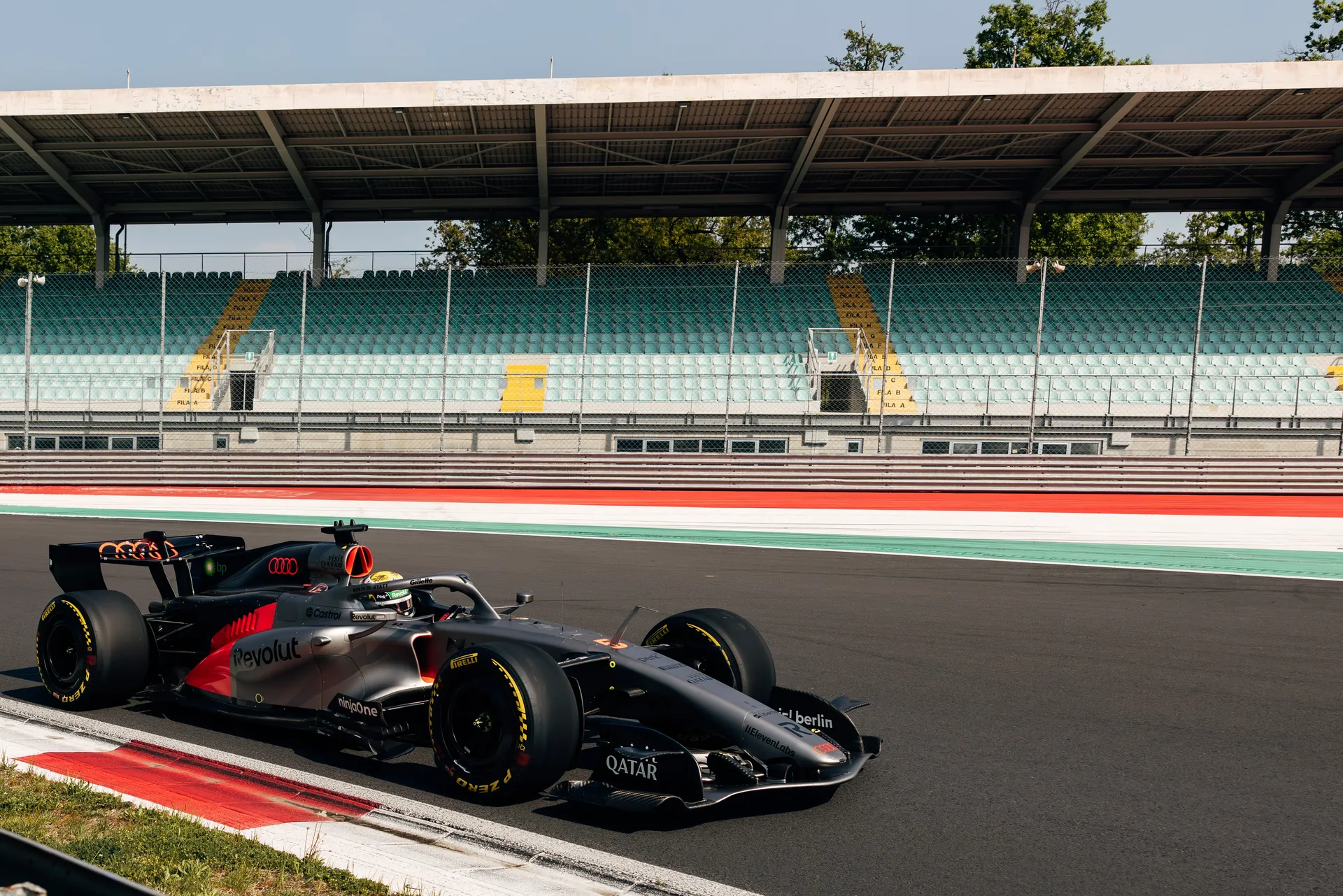 Audi R26 Formula 1® car driving through a corner at Monza