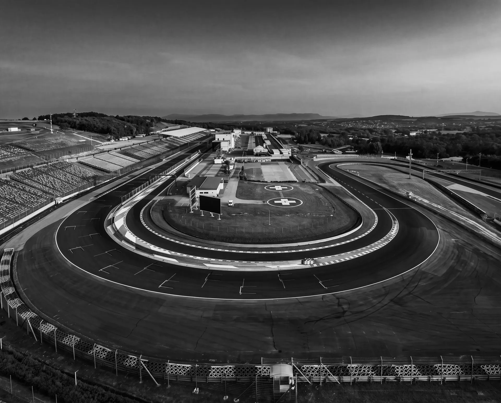 Black-and-white aerial of the Hungaroring's final corner and grandstands before the Audi Revolut F1® Team Hungarian GP