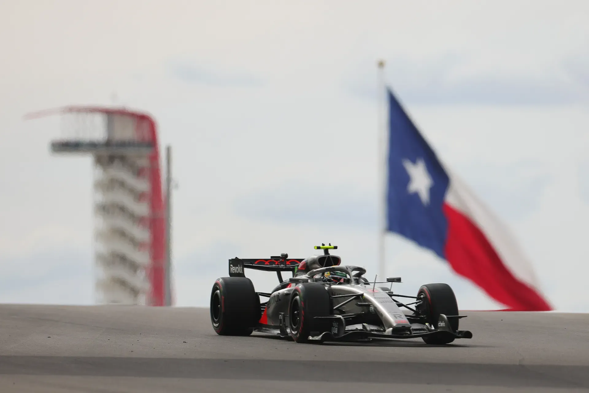 Car of the Audi Revolut F1® Team driving on track with the observation tower and a Texas flag behind in Austin