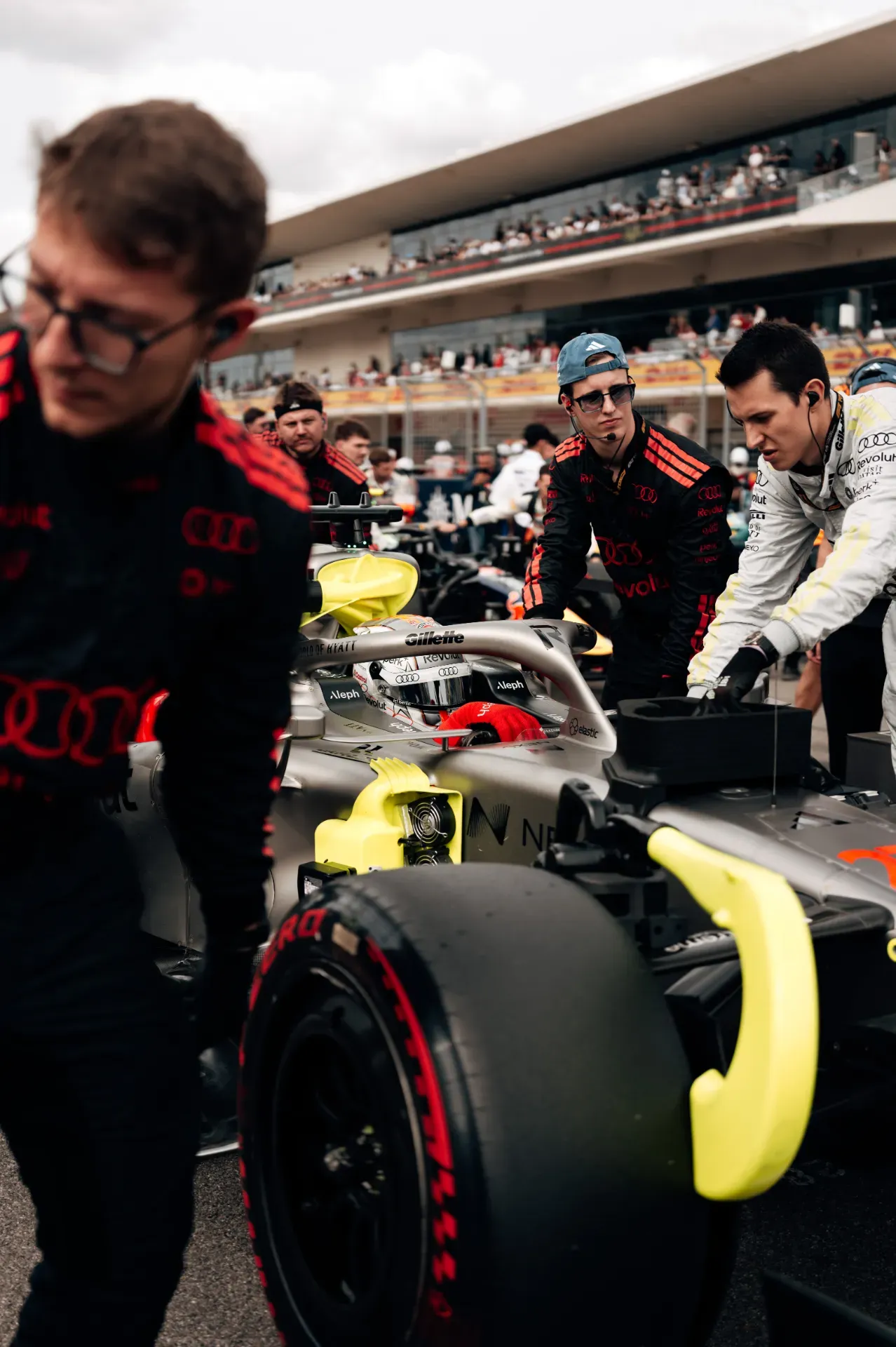 Nico Hulkenberg in the cockpit of the Audi Revolut F1® Team car as mechanics push it on the starting grid in Austin