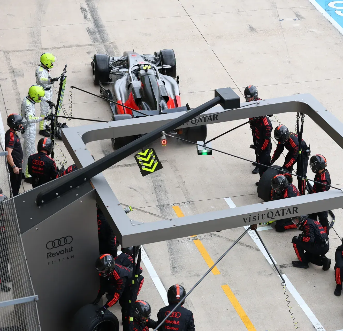 Mechanics of the Audi Revolut F1® Team carrying out a pit stop on the car in the pit lane in Austin