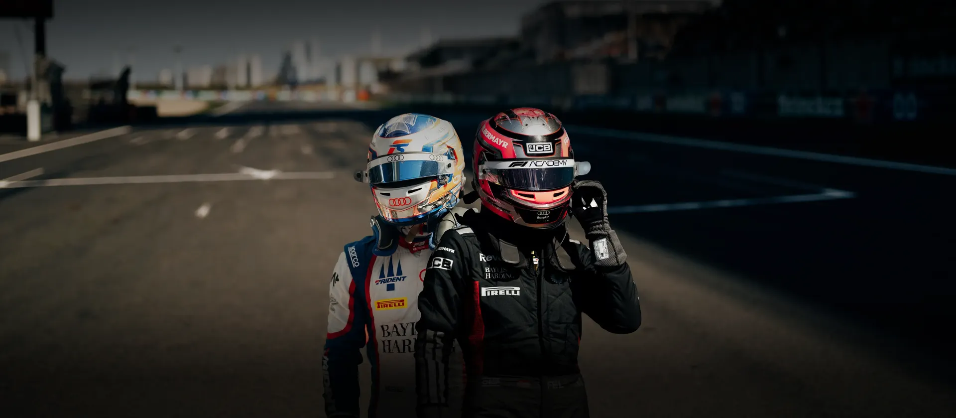 Emma Felbermayr and Freddie Slater drivers at the Audi Revolut F1® Team Academy Driver Development Programme, side by side on the racetrack