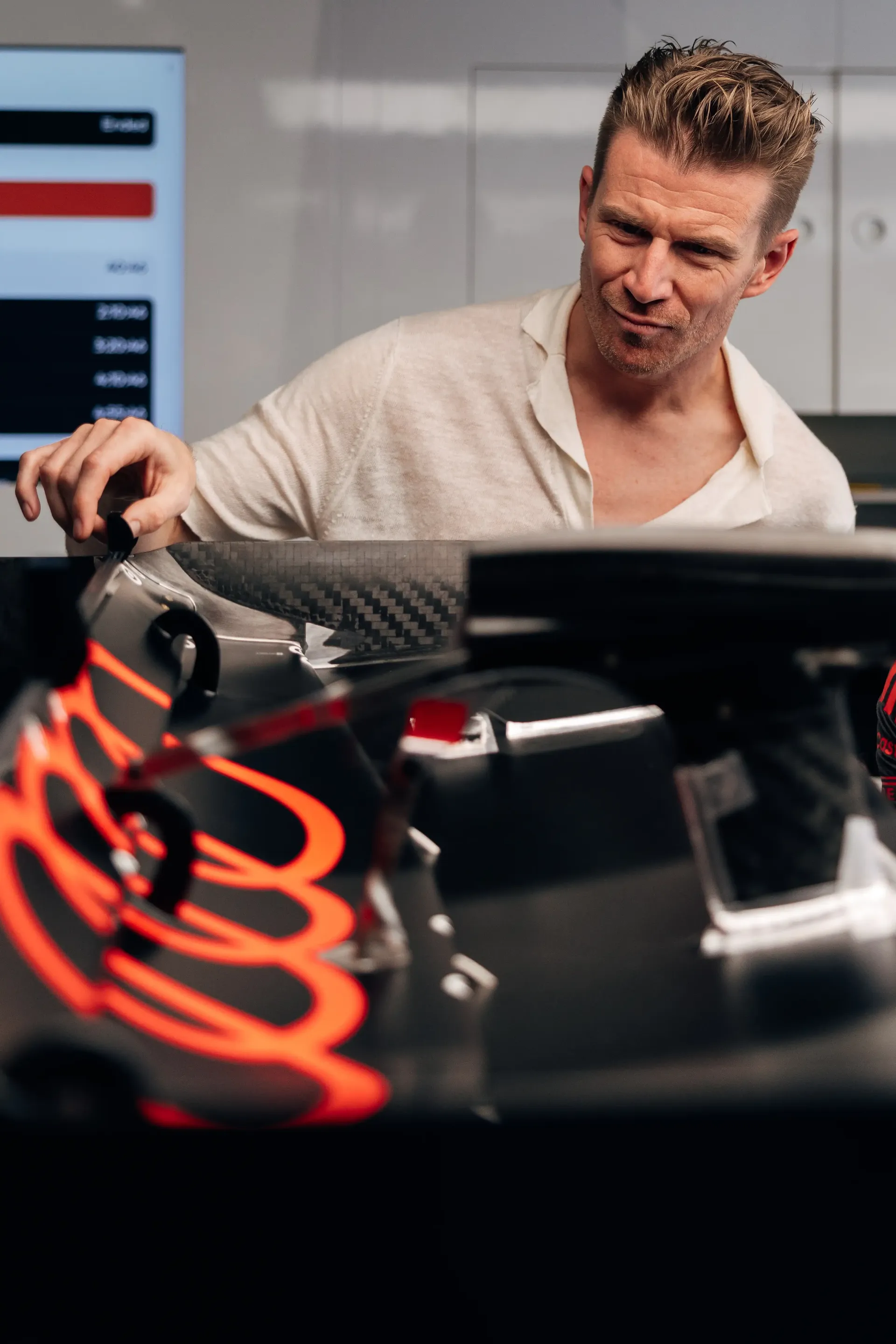 An Audi Revolut F1® Team driver Nico Hulkenberg admires the AUdi R26 rear wing inside the garage ahead of the Formula 1® Austrian Grand Prix at the Red Bull Ring.