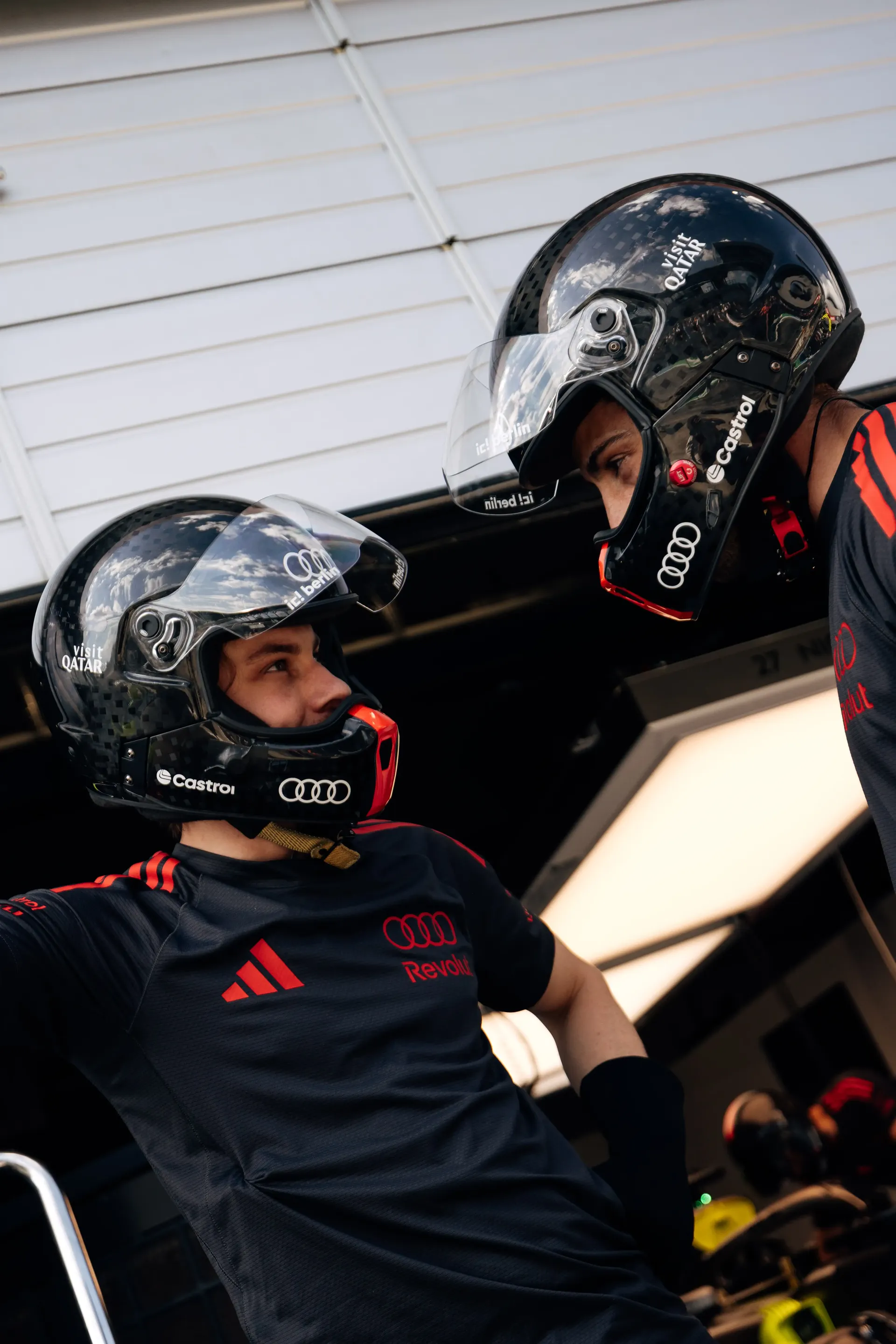 Audi Revolut F1® Team pit stop crew members in helmets prepare for pit stop practice ahead of the Formula 1® Austrian Grand Prix at the Red Bull Ring.