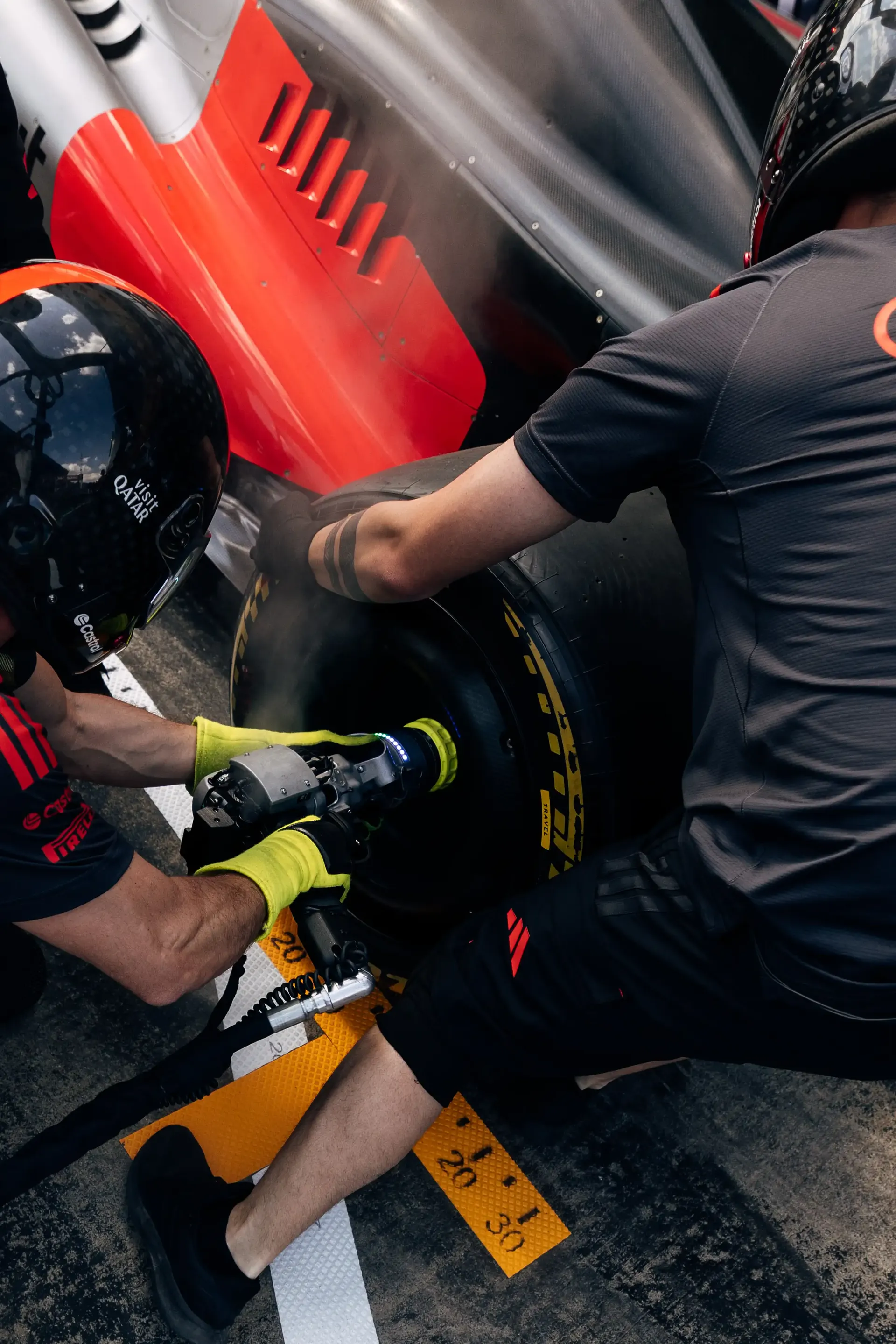 Audi Revolut F1® Team pit stop crew members perform a wheel change during pit stop practice ahead of the Formula 1® Austrian Grand Prix at the Red Bull Ring.