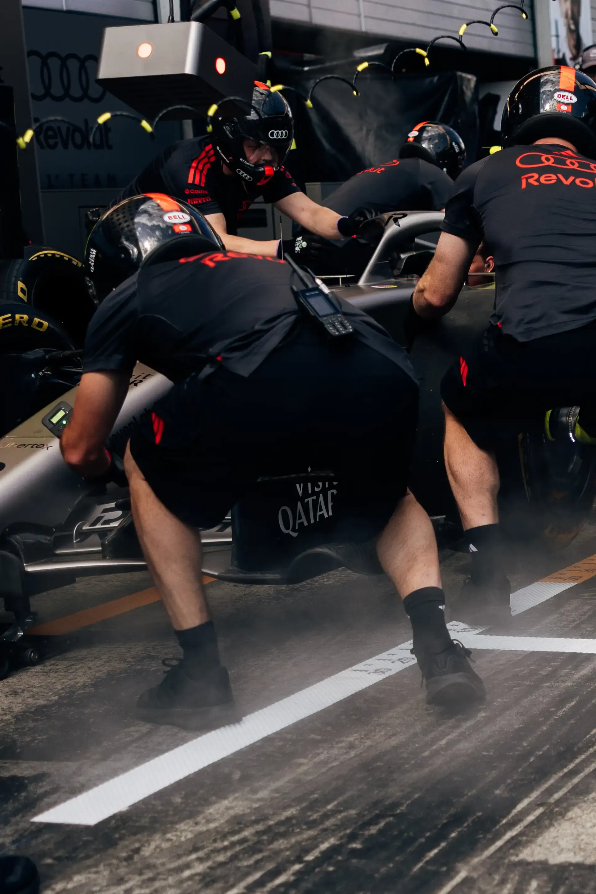 Audi Revolut F1® Team pit stop crew members sprint into position during pit stop practice ahead of the Formula 1® Austrian Grand Prix at the Red Bull Ring.