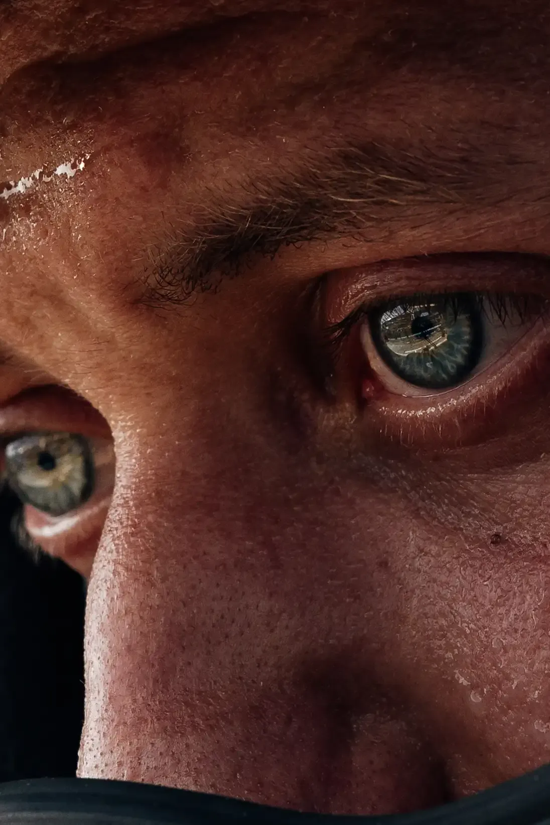 Close-up portrait of an Audi Revolut F1® Team pit stop crew member wearing a helmet ahead of the Formula 1® Austrian Grand Prix at the Red Bull Ring.