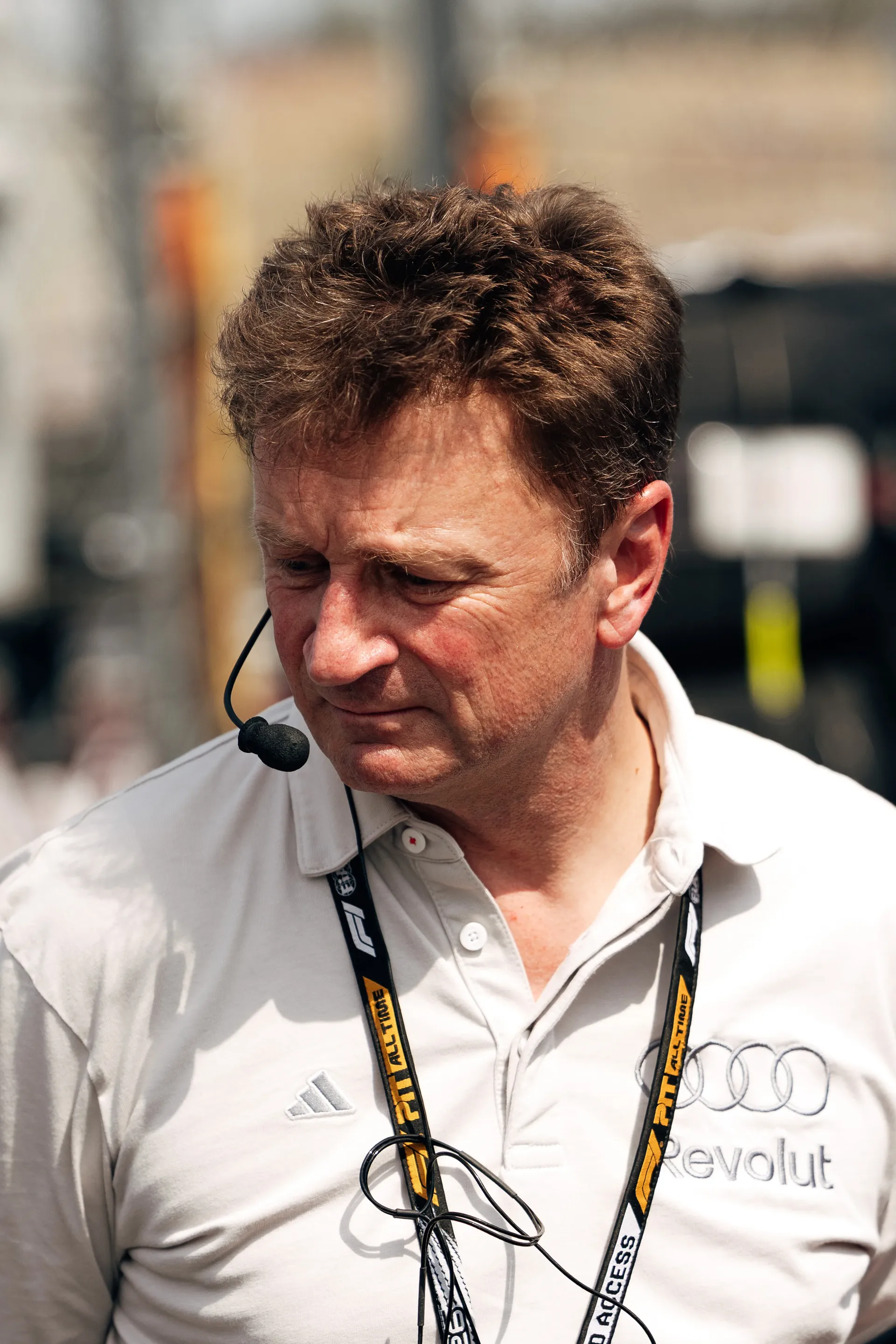 Audi Revolut F1® Team racing director Allan McNish communicating at the paddock weaering headset