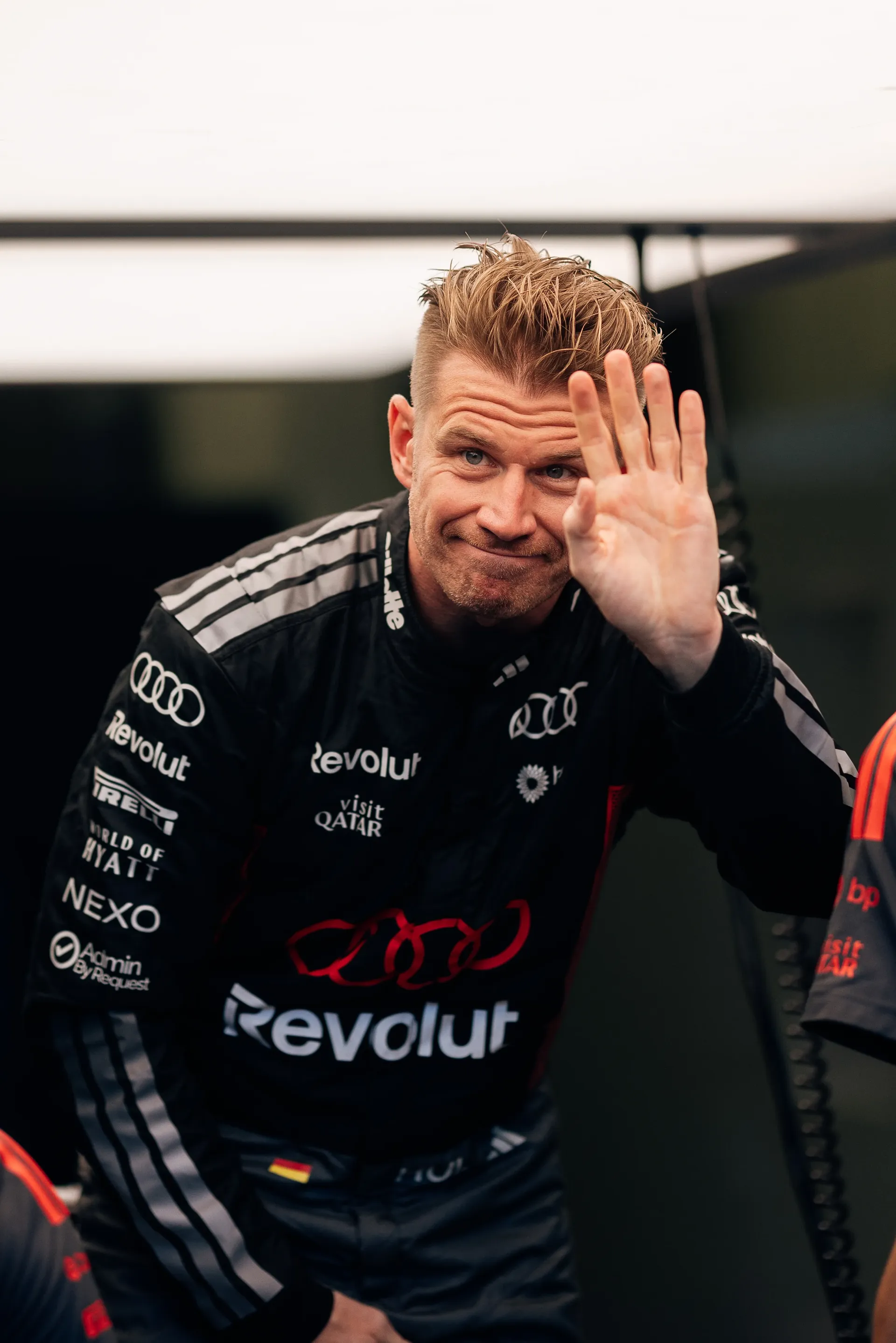 Close up of Audi Revolut F1® Team driver Nico Hulkenberg inside the garage waving