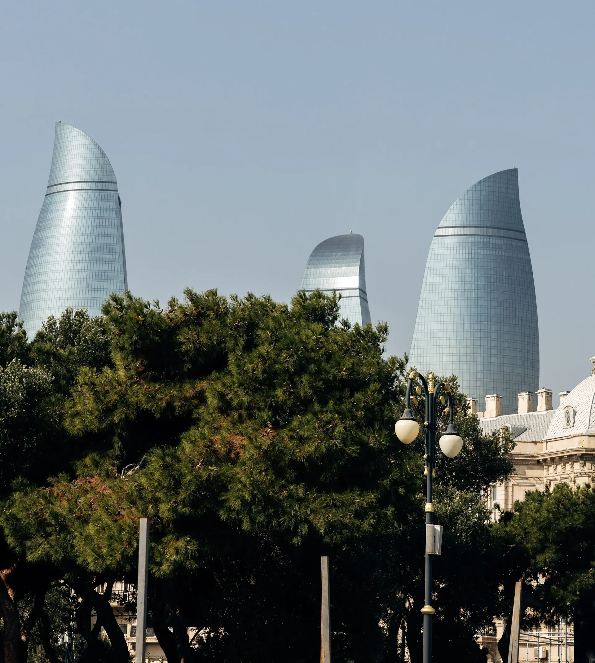 Flame Towers rising above the trees in Baku, Azerbaijan
